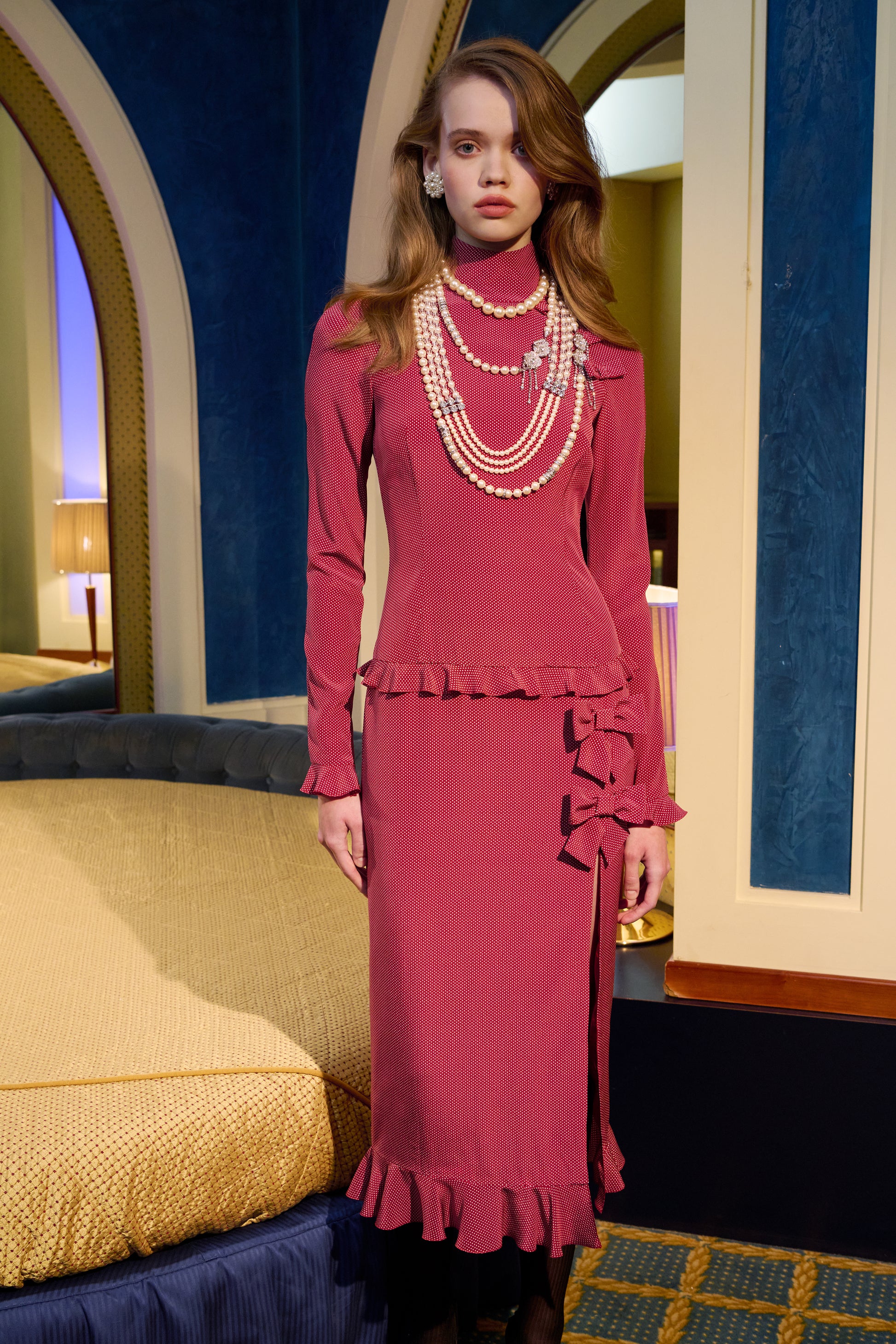 Bordeaux and white small polka-dot print silk crêpe de chine midi dress cut to a fitted silhouette with a high neckline and long sleeves. Finished with ruffled trims and bows.

Look 1 – Fall Winter 2026 Lookbook.