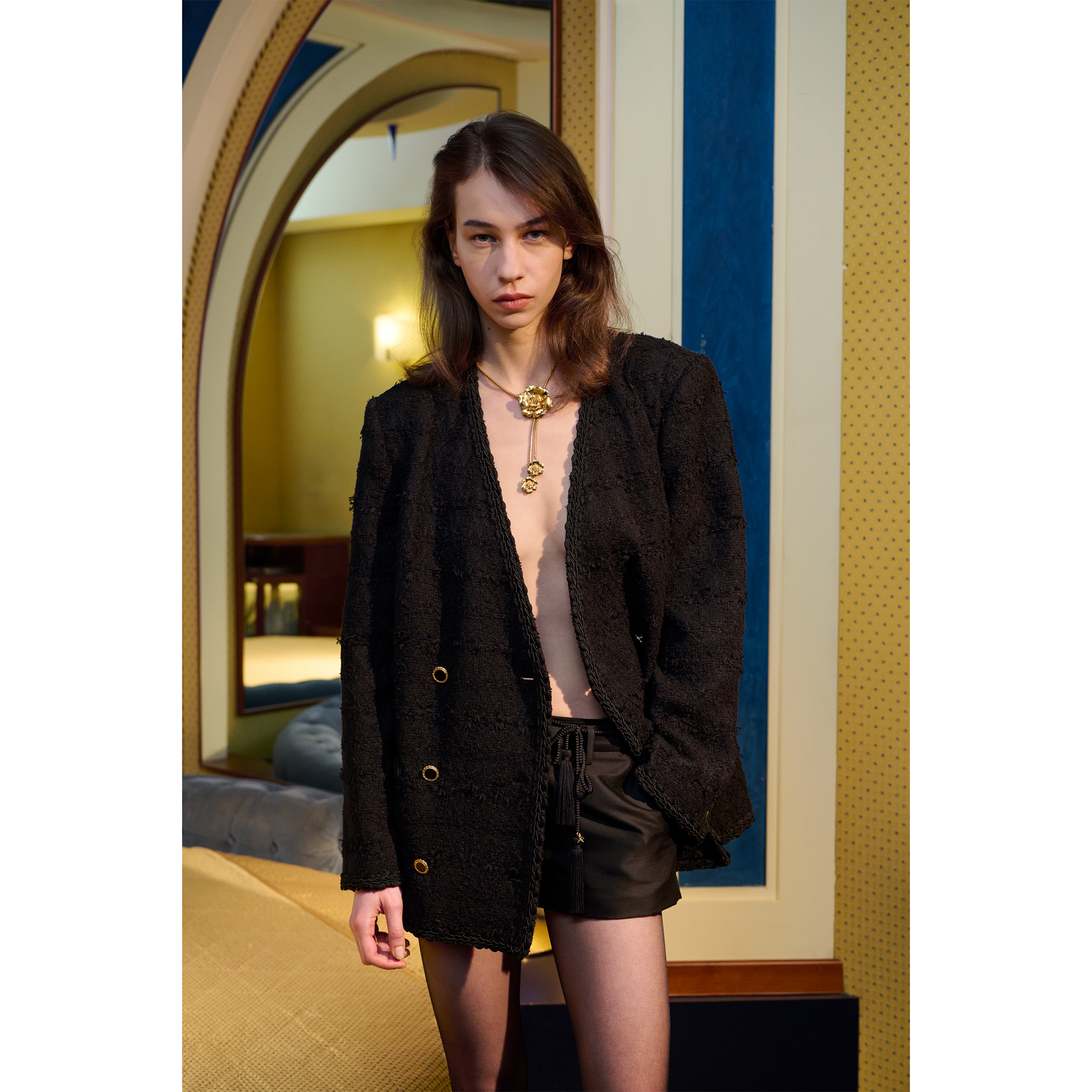 Black braided torchon belt with tassels and gold-tone "AR" logo charm.