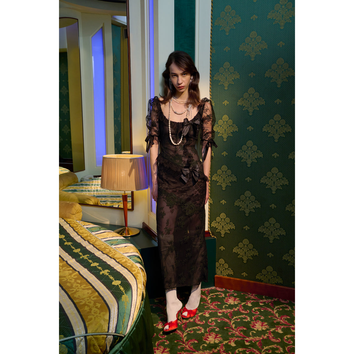 Black chantilly lace evening dress with lace inlay, featuring puff sleeves and a back split. Finished with lace trims and silk bows.

Look 21 – Fall Winter 2026 Lookbook