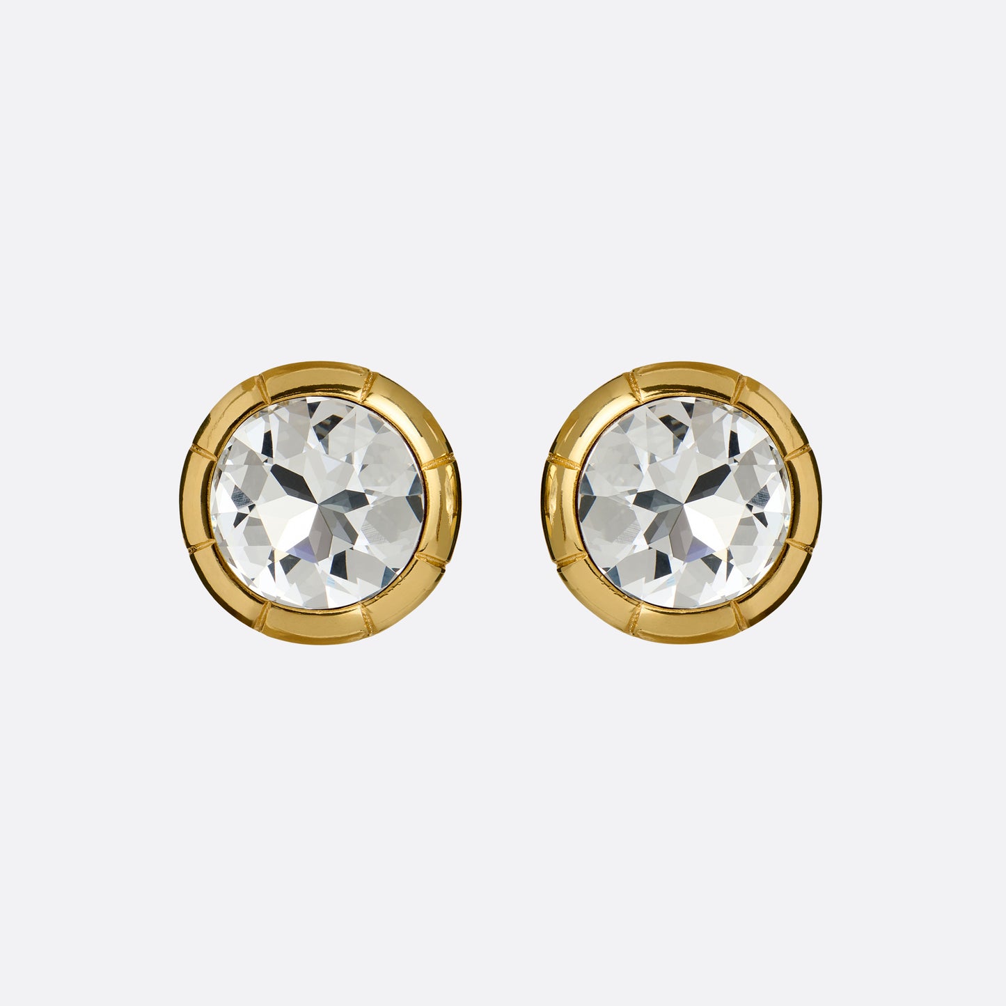 Gold-tone metal clip-on earrings with a round crystal.

Featured in the Fall Winter 2026 Lookbook.