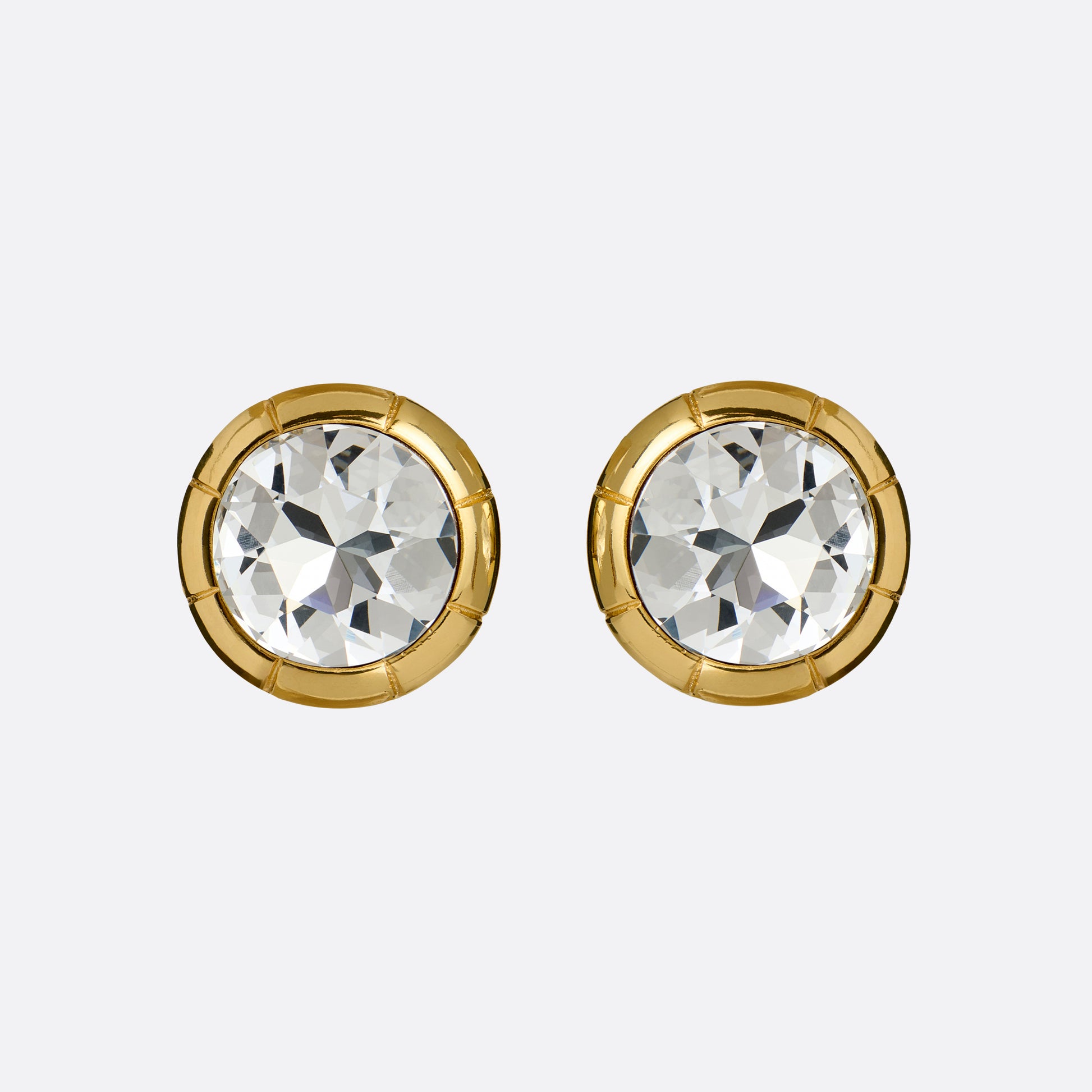 Gold-tone metal clip-on earrings with a round crystal.

Featured in the Fall Winter 2026 Lookbook.