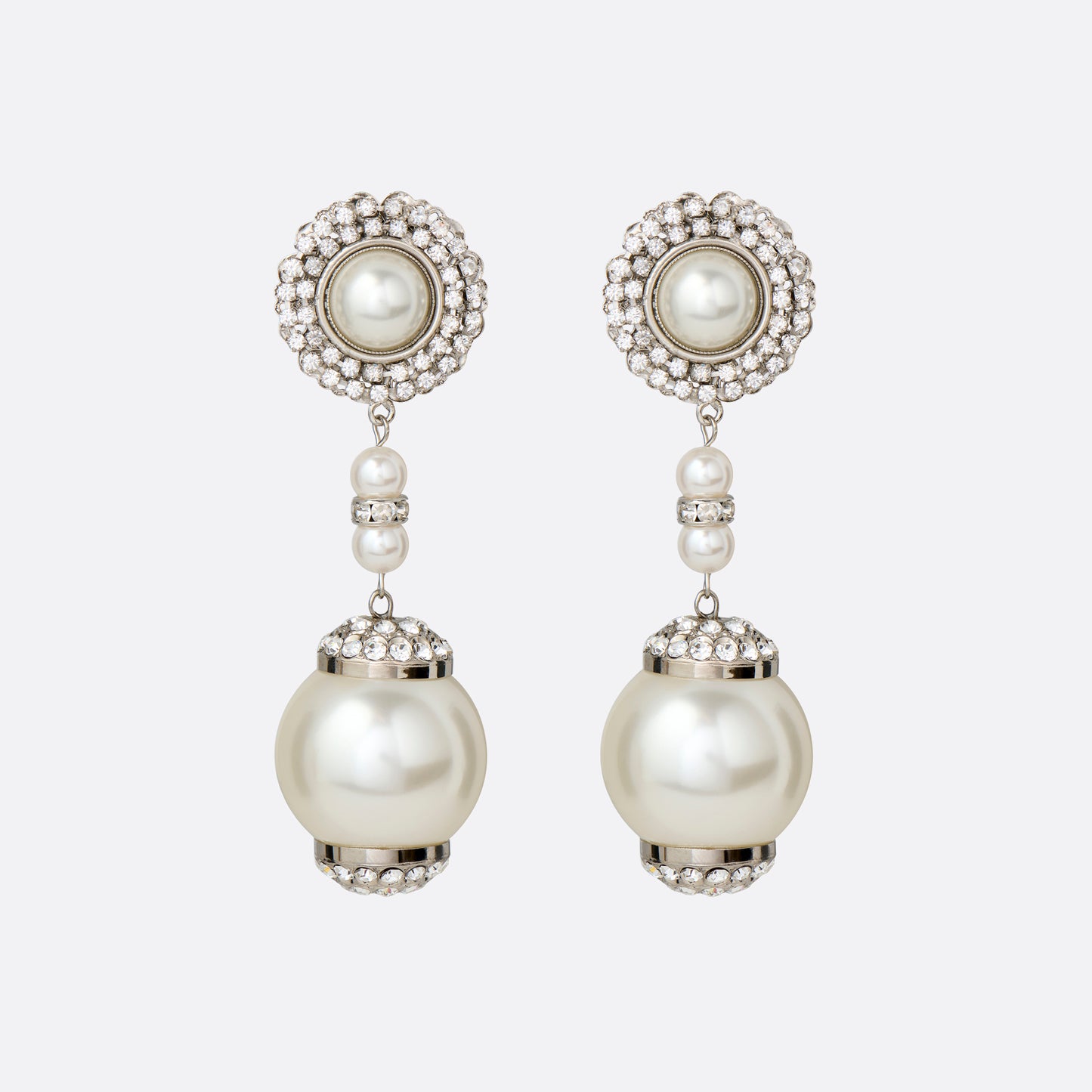 Silver-tone metal clip-on earrings with pearl and crystal details and a pendant drop.

Featured in the Fall Winter 2026 Lookbook.