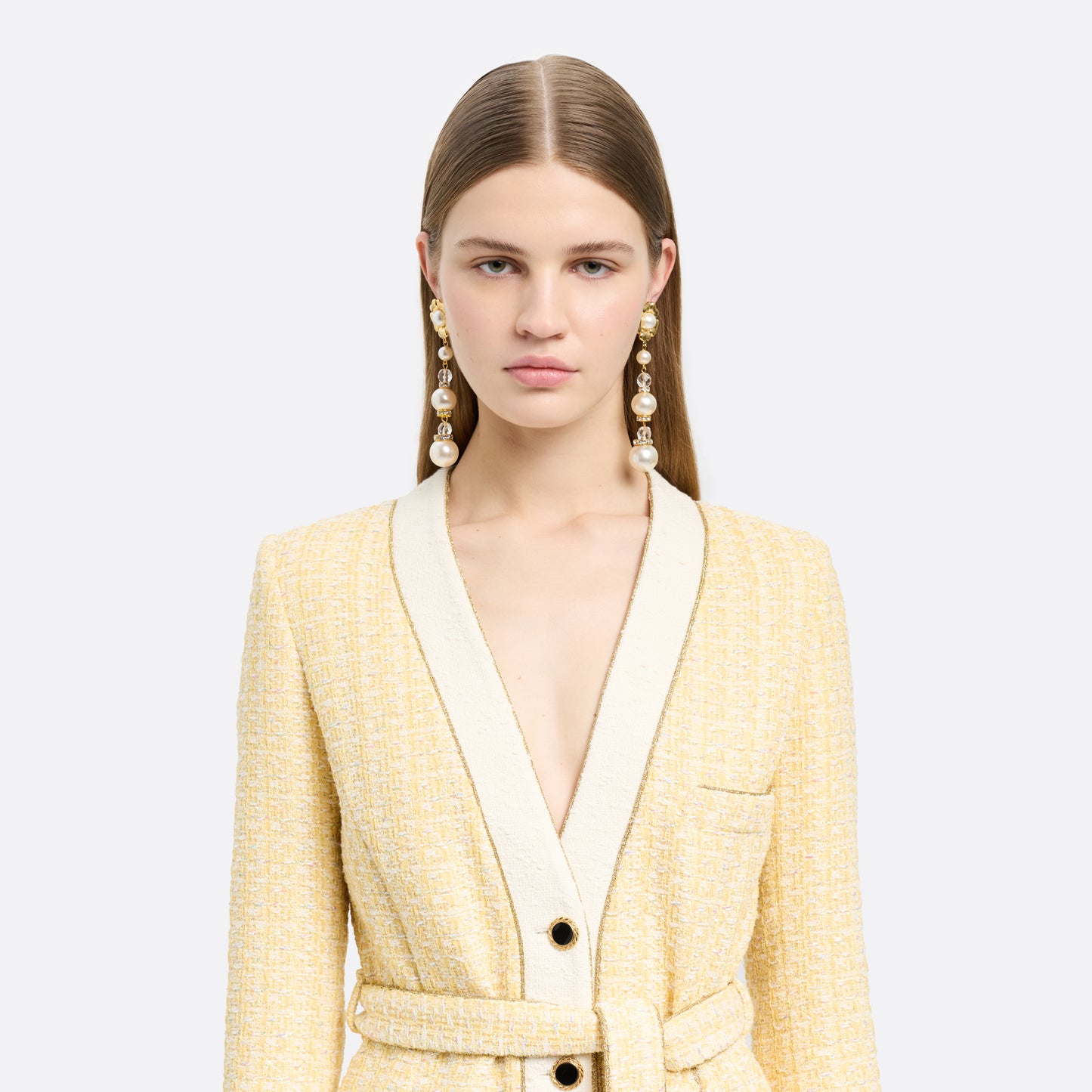 Gold-tone metal clip-on earrings with floral elements and a pearl and crystal pendant drop.

Featured in the Fall Winter 2026 Lookbook.