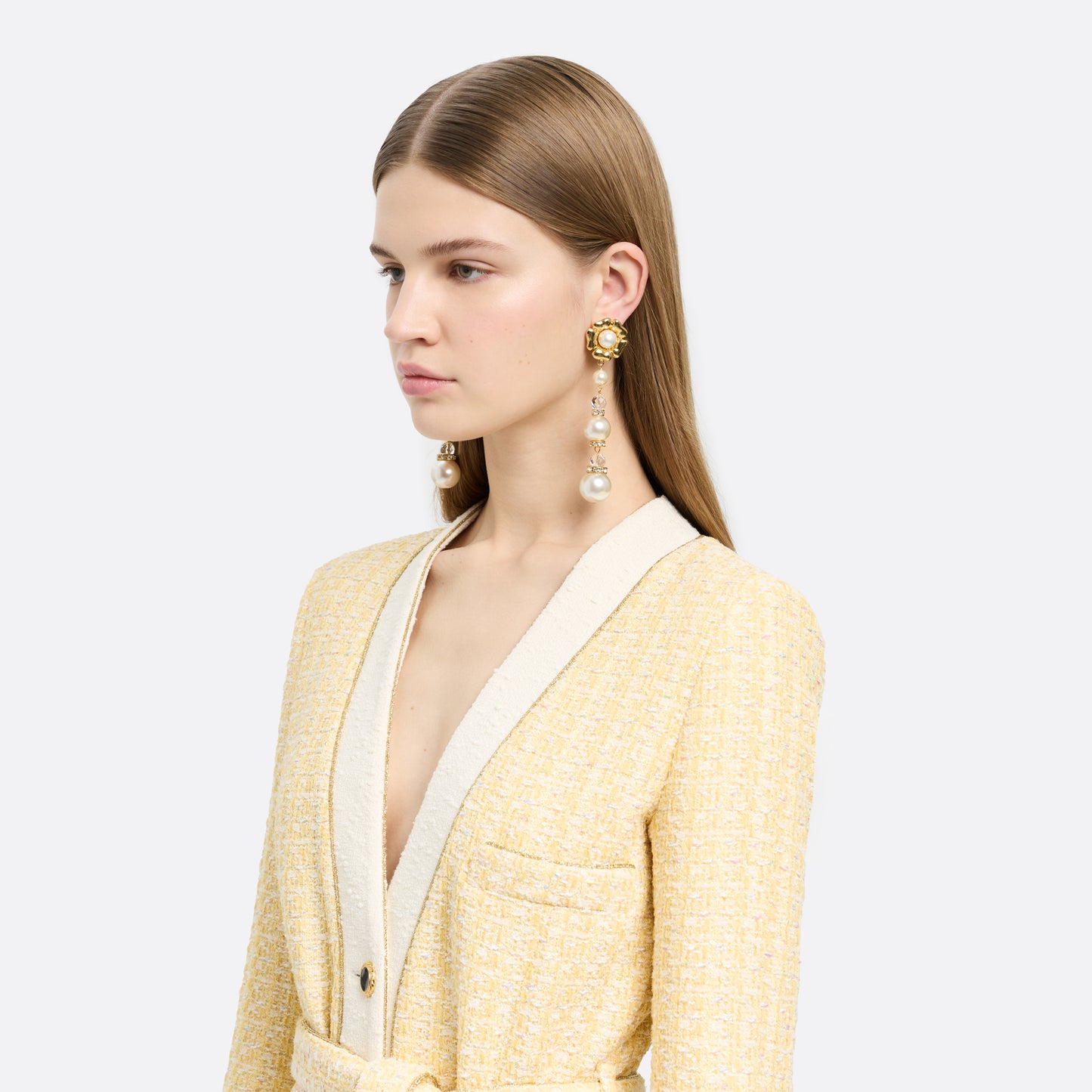 Gold-tone metal clip-on earrings with floral elements and a pearl and crystal pendant drop.

Featured in the Fall Winter 2026 Lookbook.