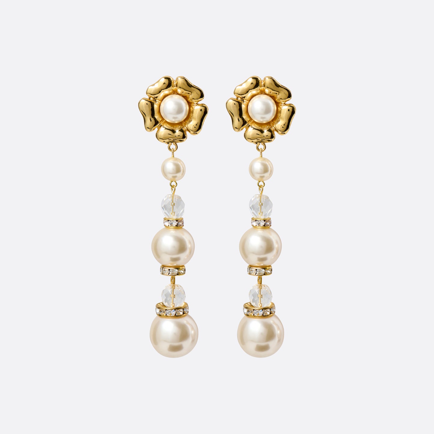 Gold-tone metal clip-on earrings with floral elements and a pearl and crystal pendant drop.

Featured in the Fall Winter 2026 Lookbook.