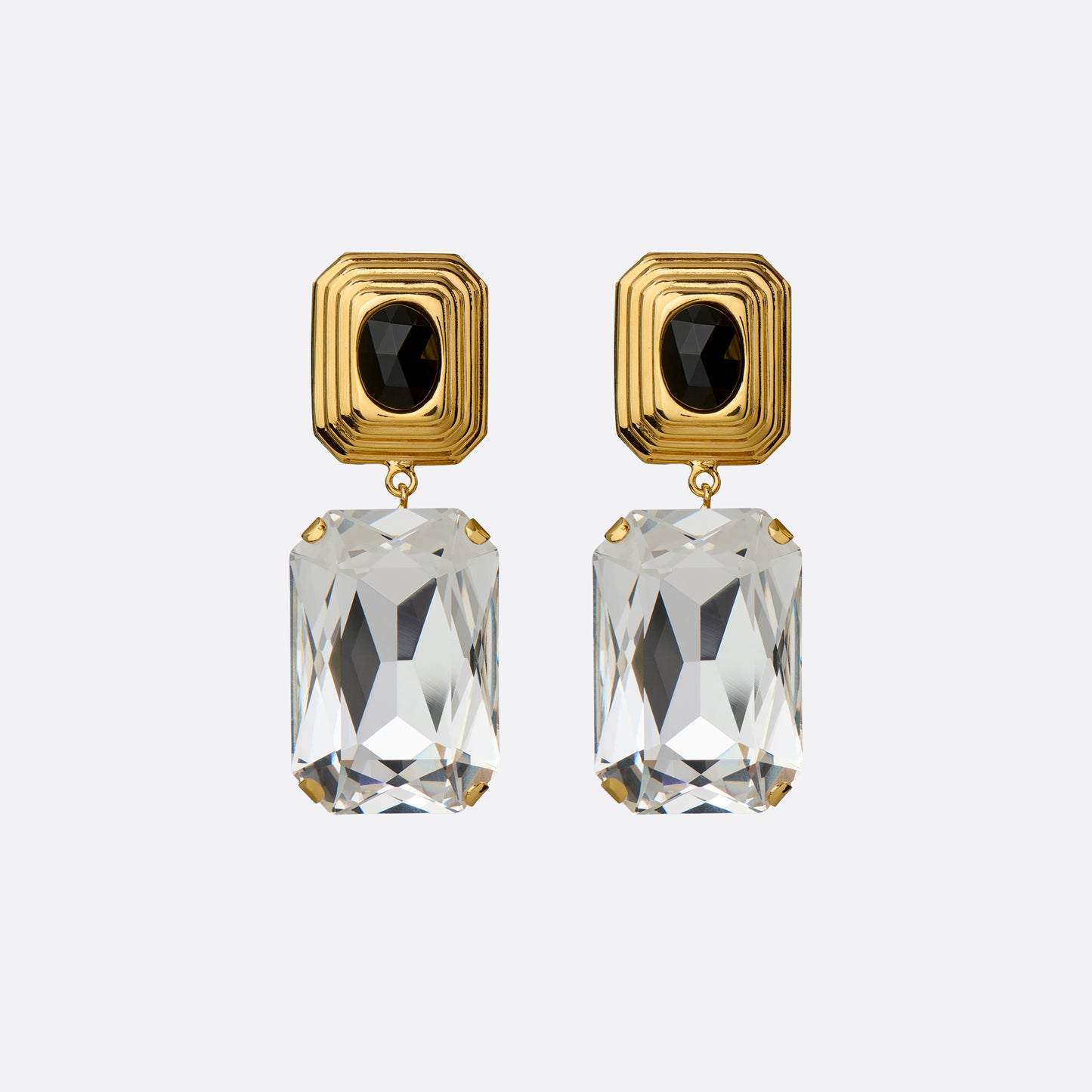 Gold-tone metal clip-on earrings with a black crystal detail and clear crystal pendant.