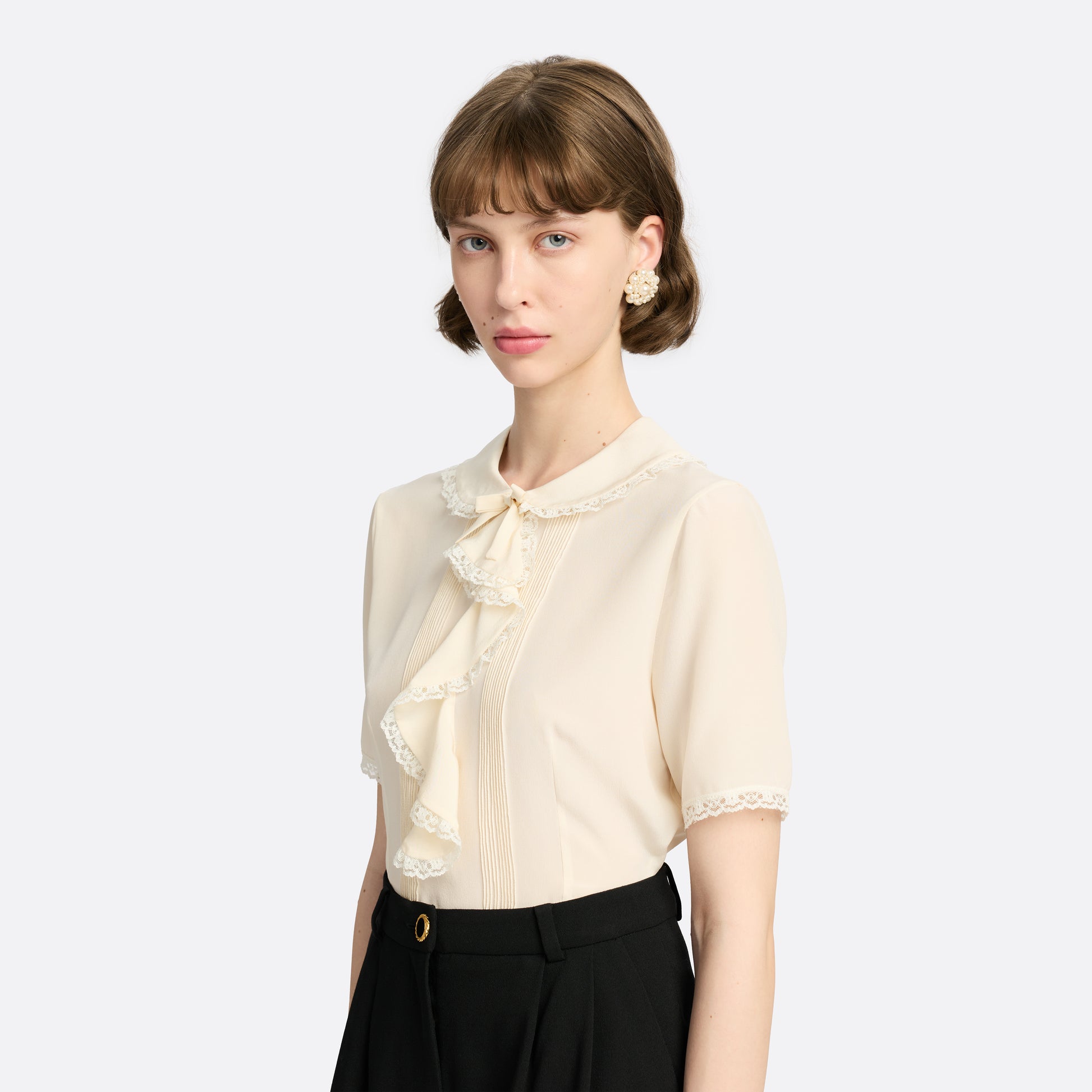 Clip-on earrings with round pearl details.

Featured in the Fall Winter 2026 Lookbook.