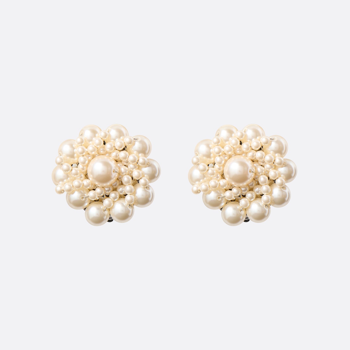 Clip-on earrings with round pearl details.

Featured in the Fall Winter 2026 Lookbook.