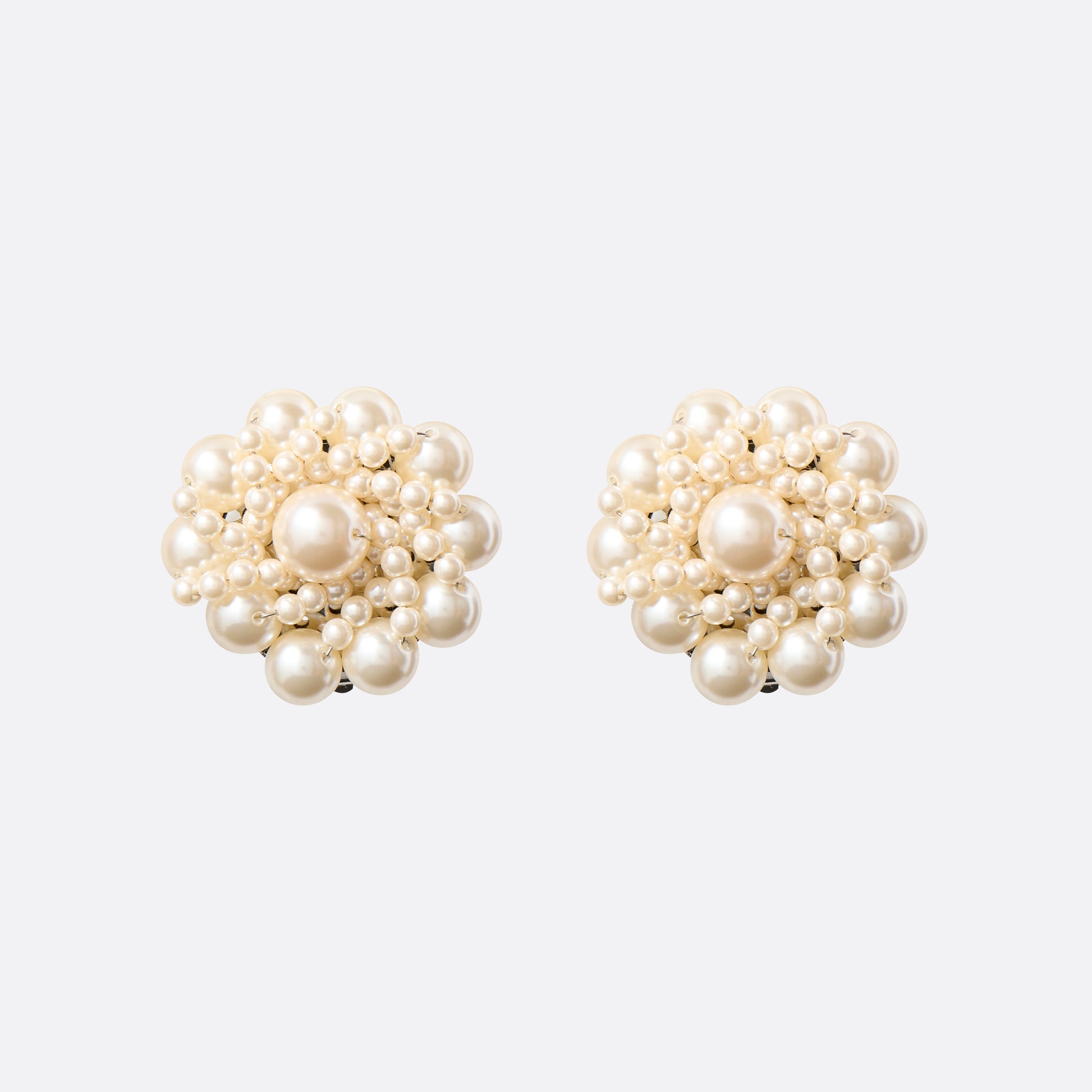 Clip-on earrings with round pearl details.

Featured in the Fall Winter 2026 Lookbook.