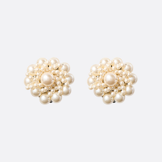 Clip-on earrings with round pearl details.

Featured in the Fall Winter 2026 Lookbook.