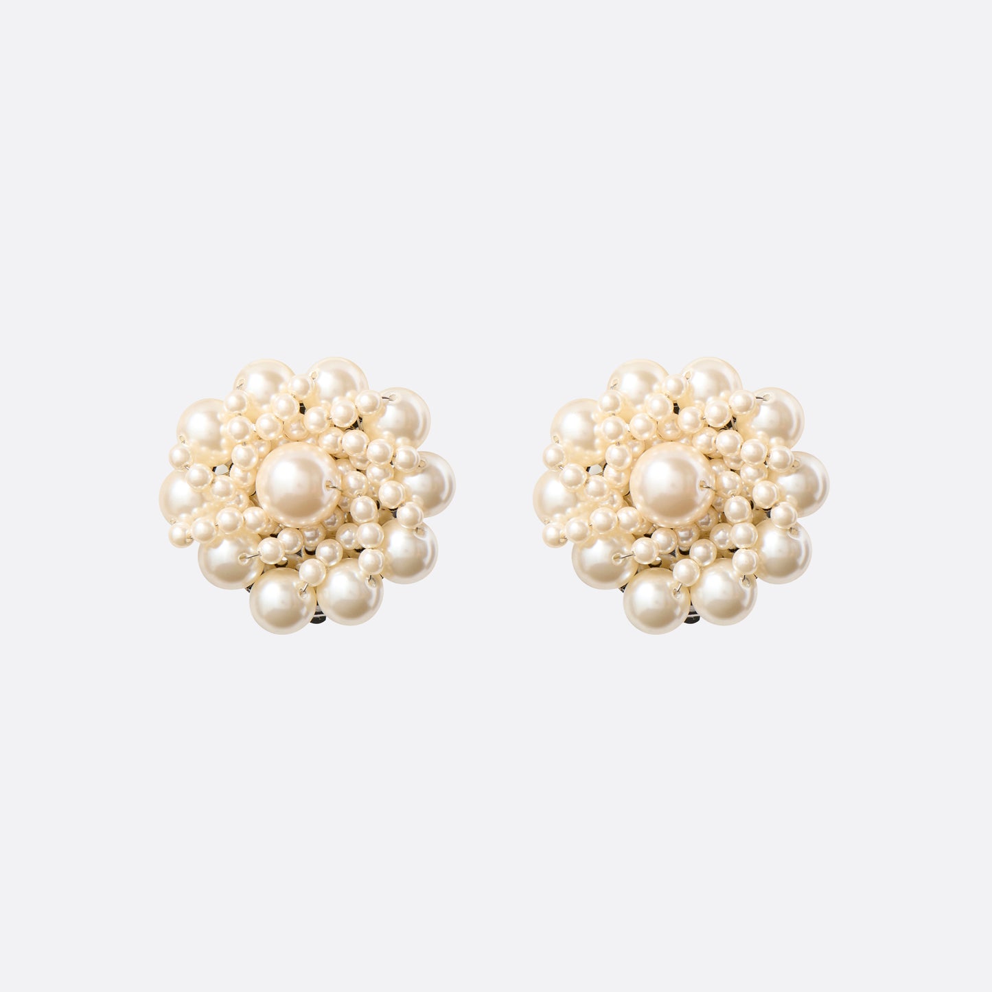 Clip-on earrings with round pearl details.

Featured in the Fall Winter 2026 Lookbook.