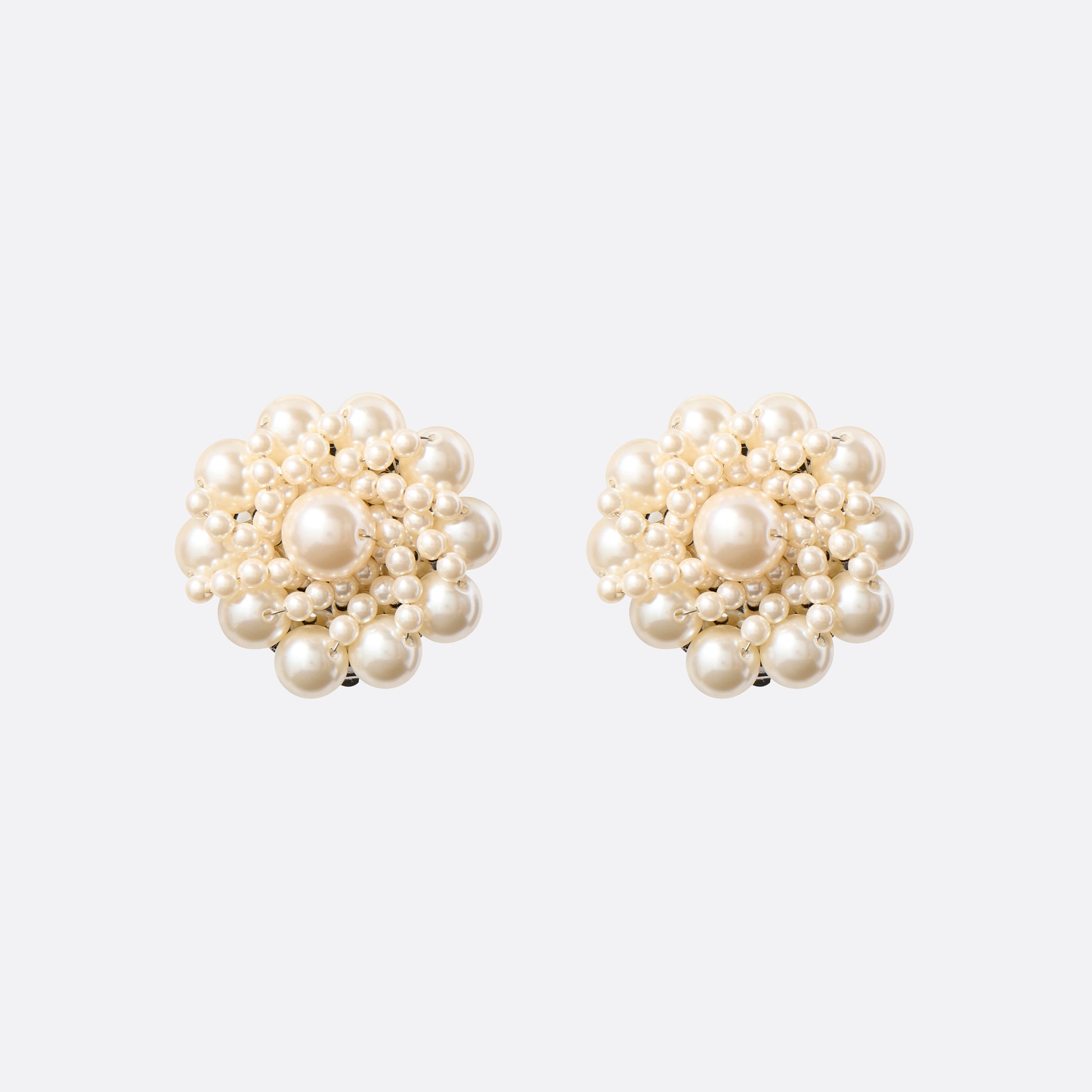 Clip-on earrings with round pearl details.

Featured in the Fall Winter 2026 Lookbook.