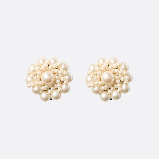 Clip-on earrings with round pearl details.

Featured in the Fall Winter 2026 Lookbook.