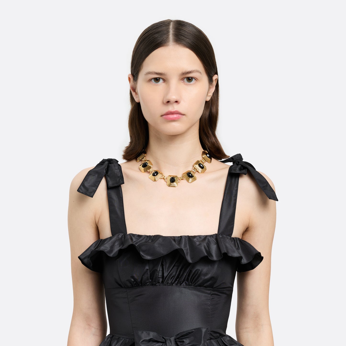 Gold-tone metal necklace composed of geometric links set with black crystals. Finished with a t-bar clasp.

Featured in the Fall Winter 2026 Lookbook.