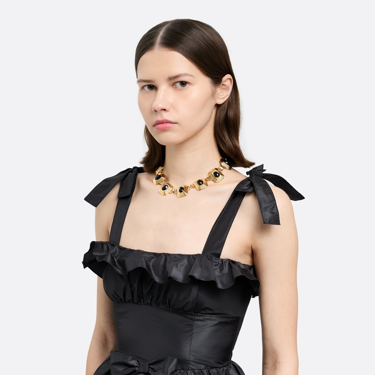 Gold-tone metal necklace composed of geometric links set with black crystals. Finished with a t-bar clasp.

Featured in the Fall Winter 2026 Lookbook.