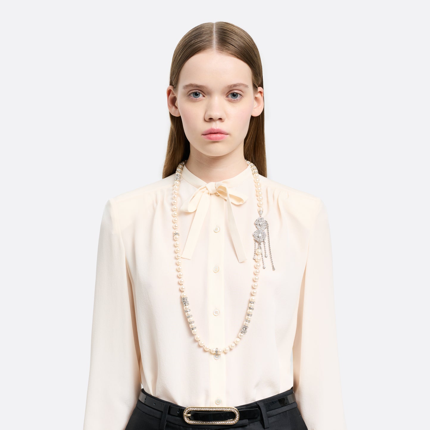 Pearl necklace punctuated with crystal spacer details. Finished with a floral side closure and crystal drop details.

Featured in the Fall Winter 2026 Lookbook.
