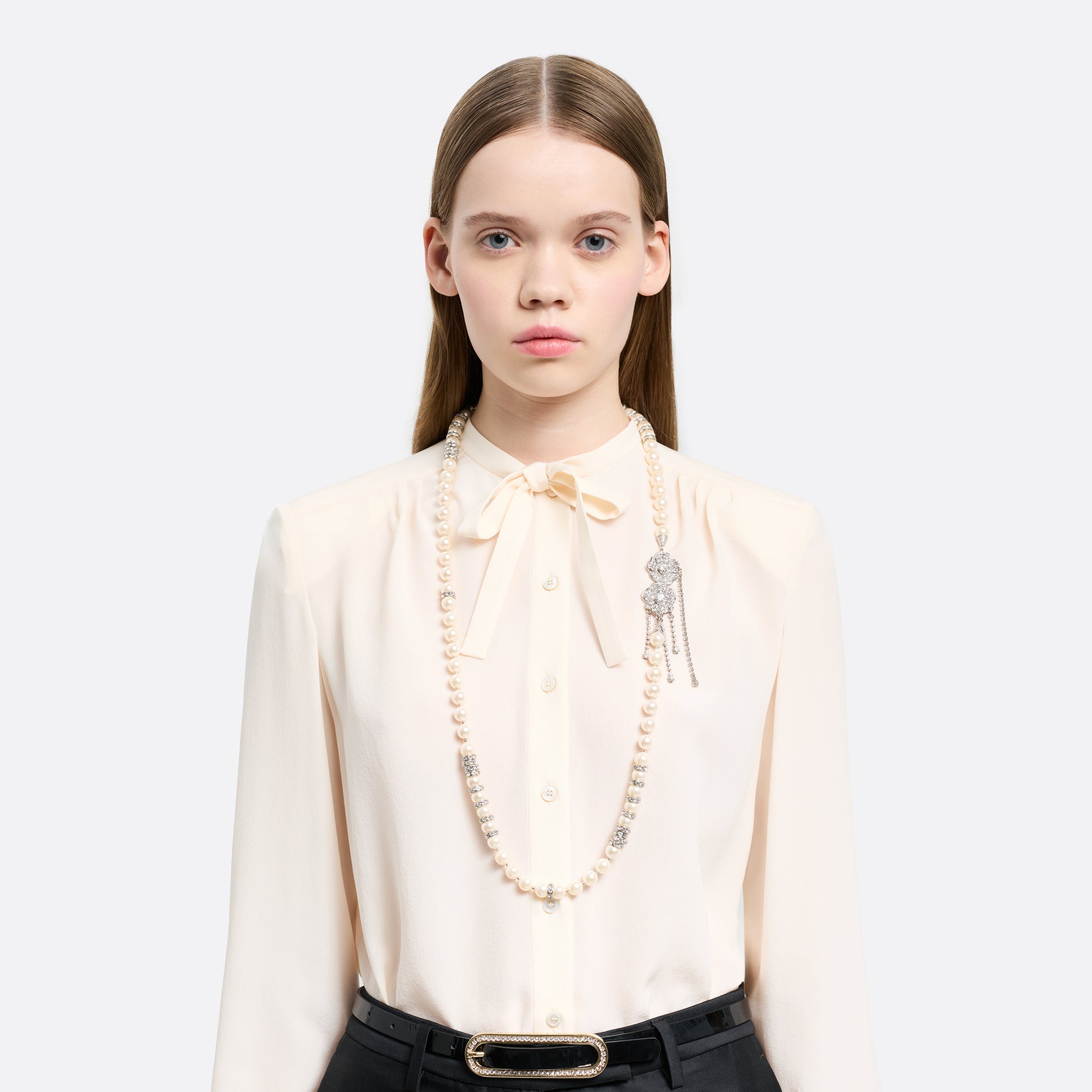 Pearl necklace punctuated with crystal spacer details. Finished with a floral side closure and crystal drop details.

Featured in the Fall Winter 2026 Lookbook.