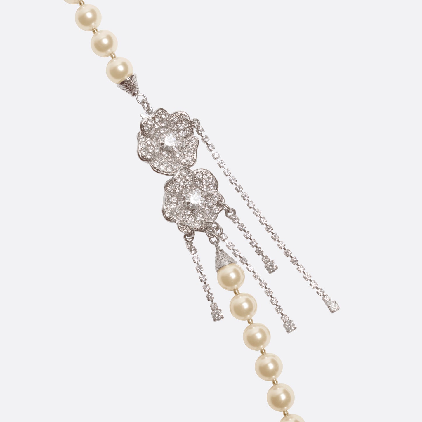 Pearl necklace punctuated with crystal spacer details. Finished with a floral side closure and crystal drop details.

Featured in the Fall Winter 2026 Lookbook.