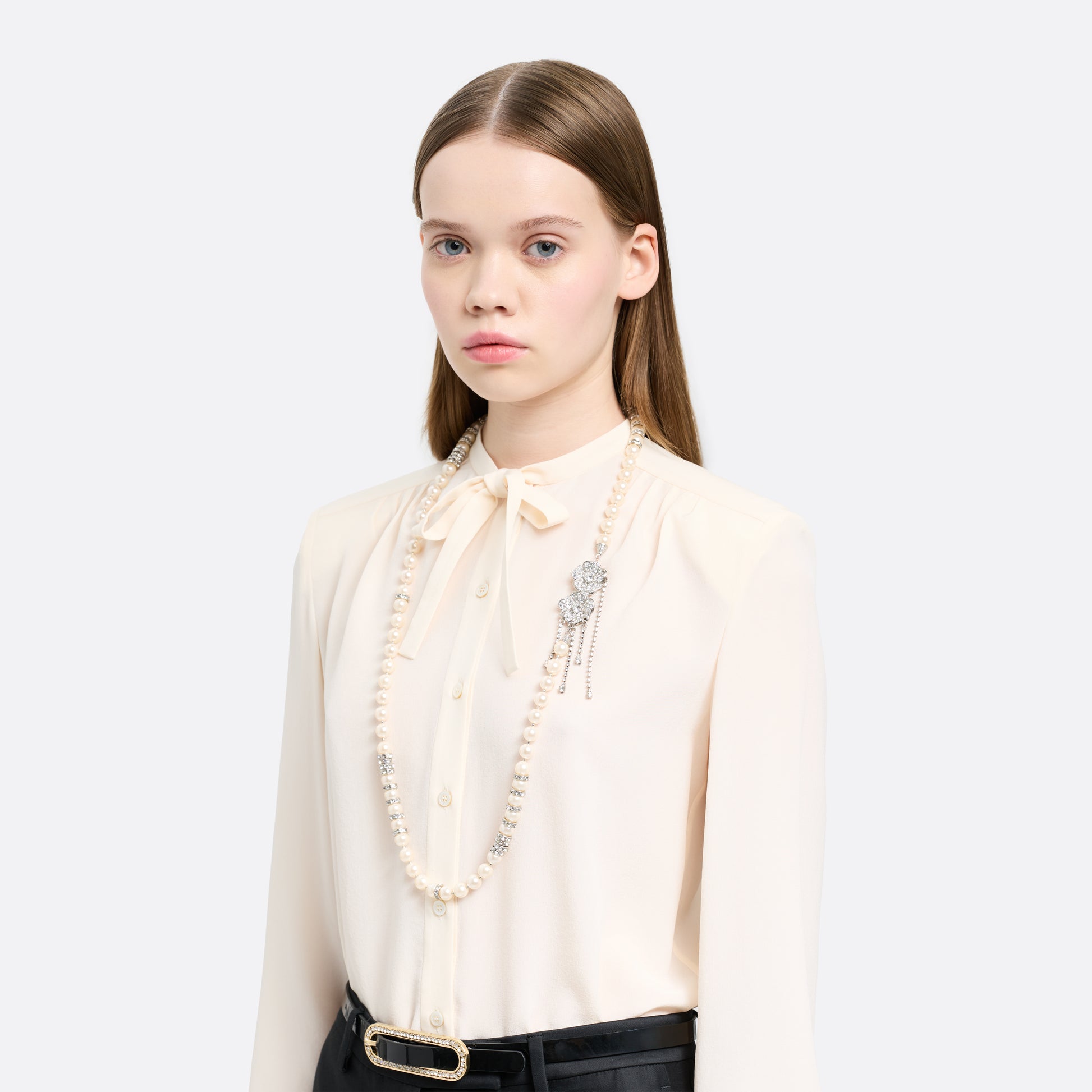 Pearl necklace punctuated with crystal spacer details. Finished with a floral side closure and crystal drop details.

Featured in the Fall Winter 2026 Lookbook.