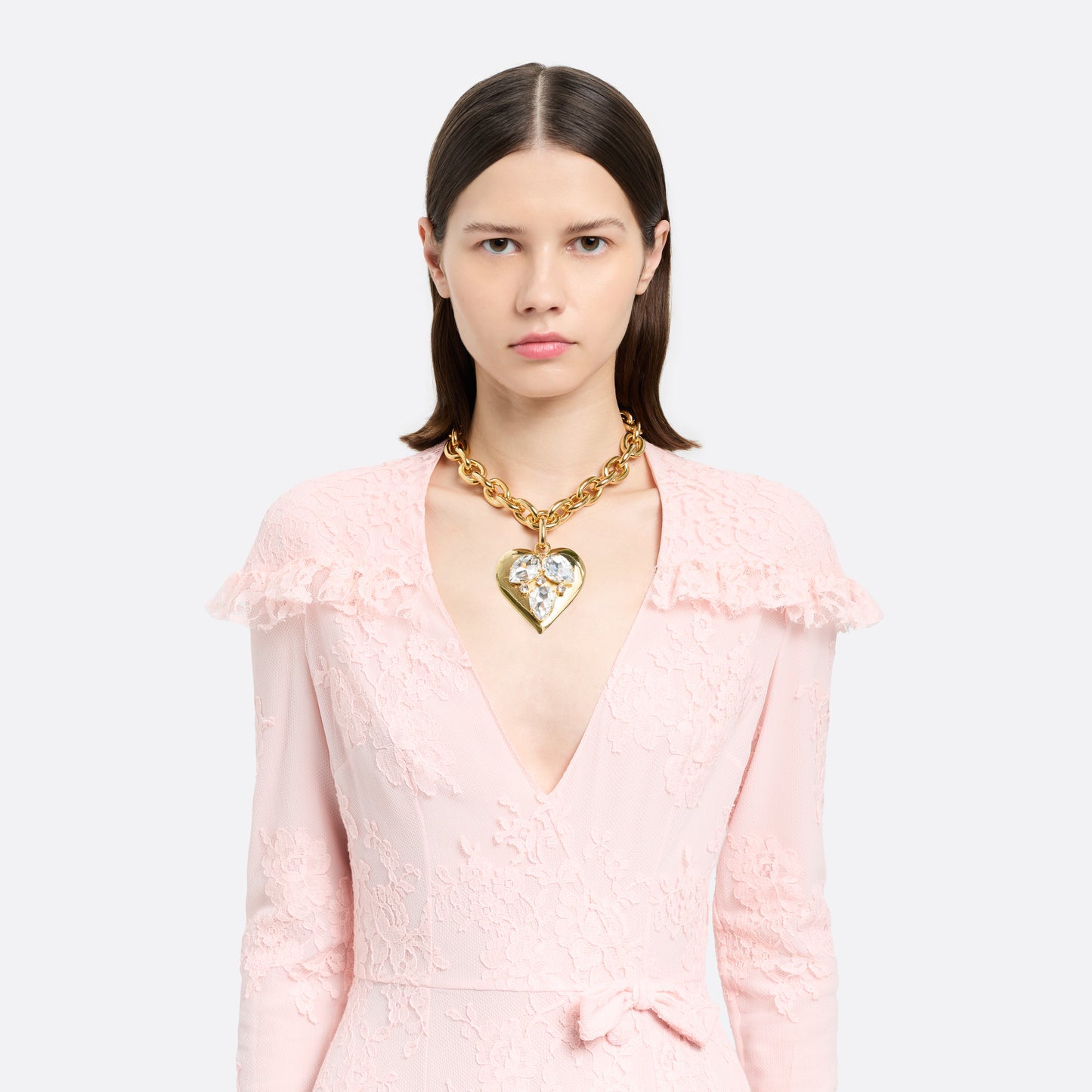 Gold-tone metal necklace with a link chain and a crystal-embellished heart pendant. Finished with an adjustable chain fastening.

Featured in the Fall Winter 2026 Lookbook.