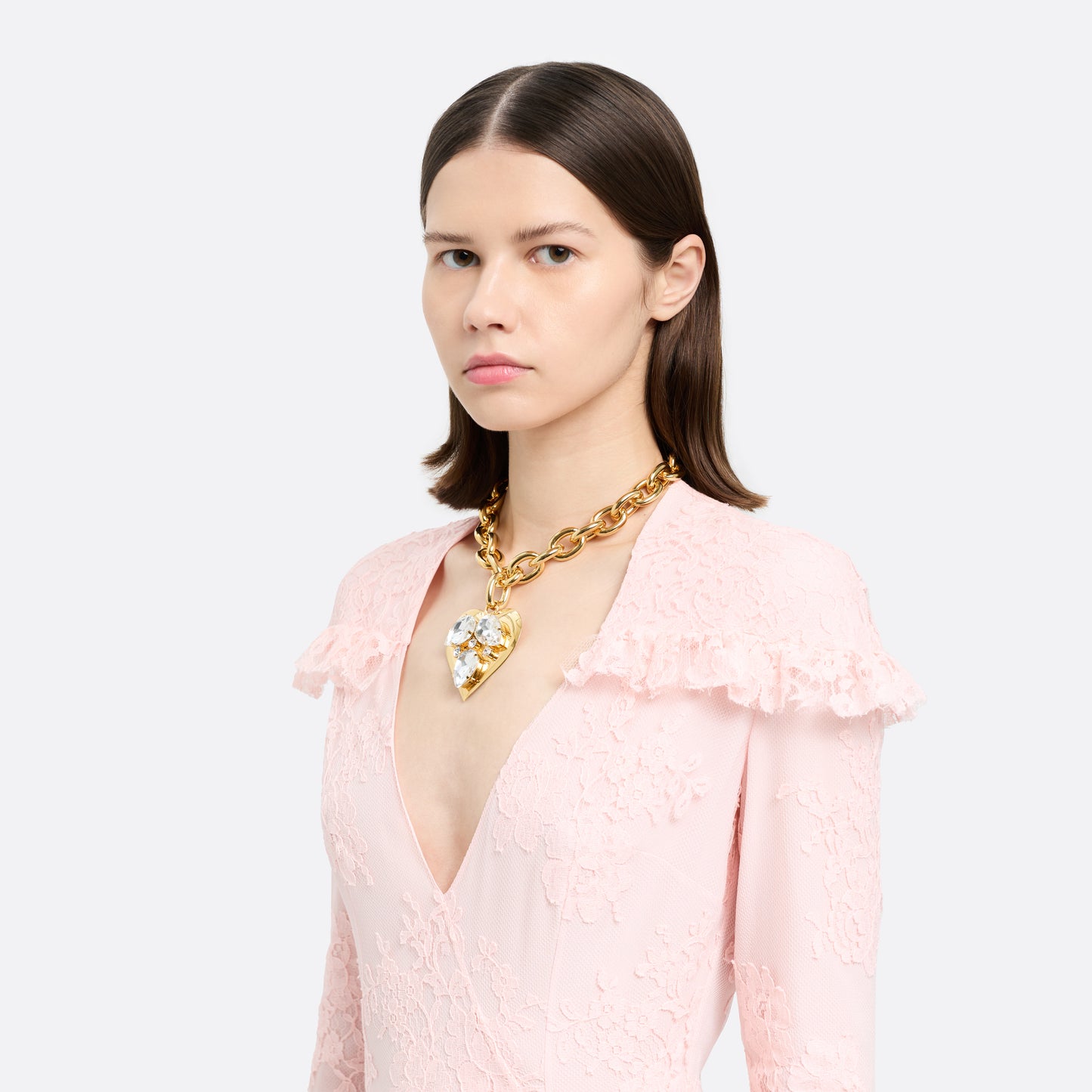 Gold-tone metal necklace with a link chain and a crystal-embellished heart pendant. Finished with an adjustable chain fastening.

Featured in the Fall Winter 2026 Lookbook.