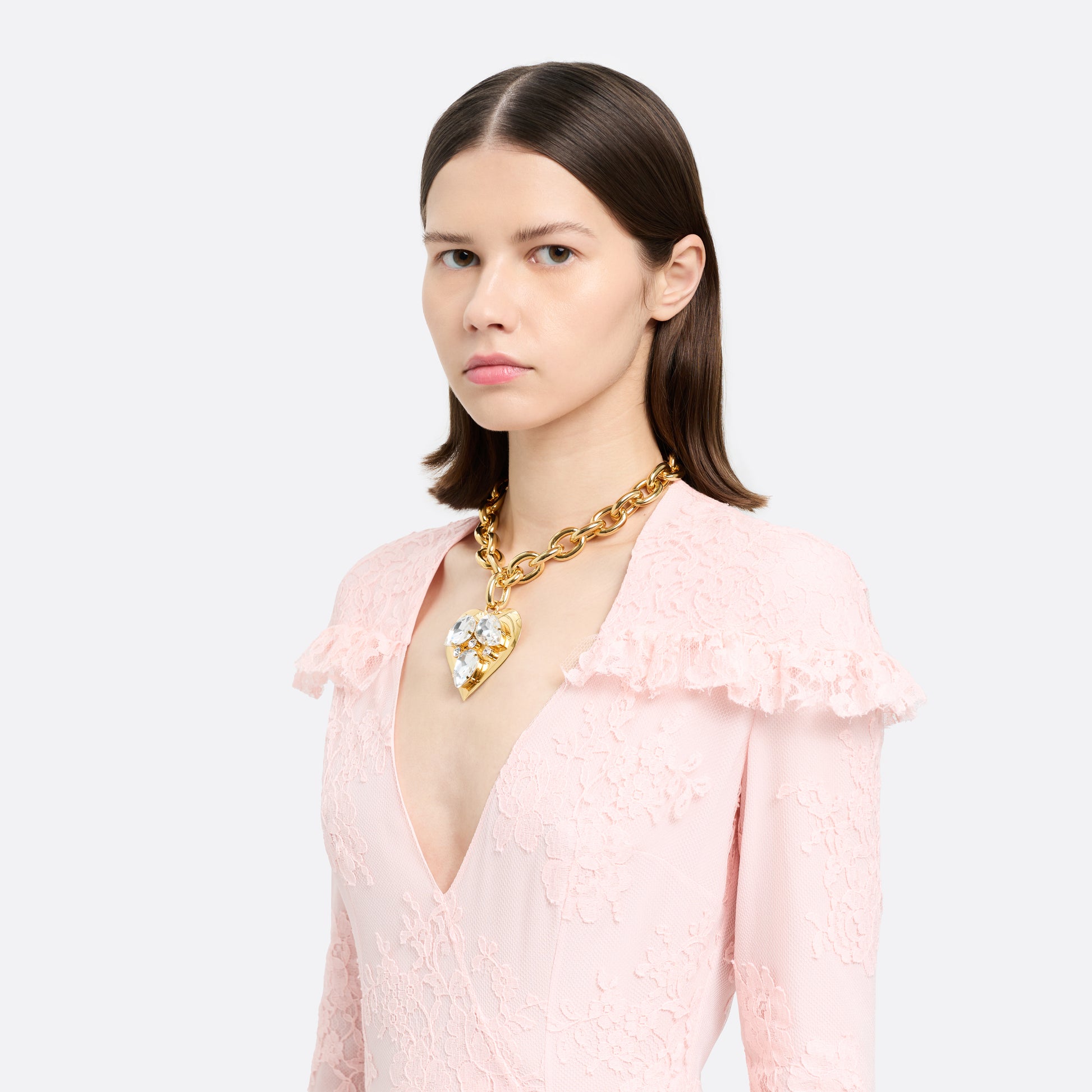 Gold-tone metal necklace with a link chain and a crystal-embellished heart pendant. Finished with an adjustable chain fastening.

Featured in the Fall Winter 2026 Lookbook.