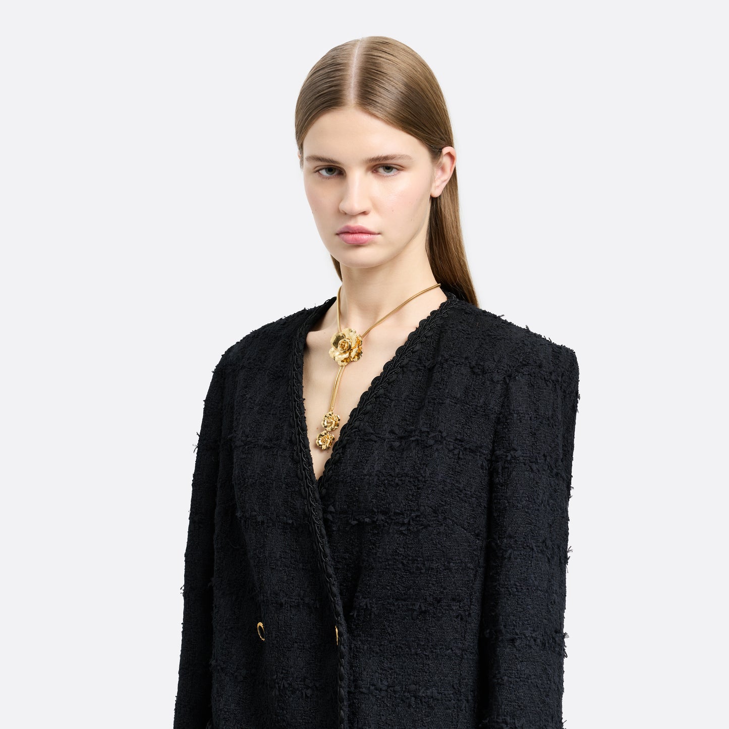 Gold-tone metal necklace centred by a floral motif. Finished with suspended flower charms and an adjustable chain fastening.

Featured in the Fall Winter 2026 Lookbook.
