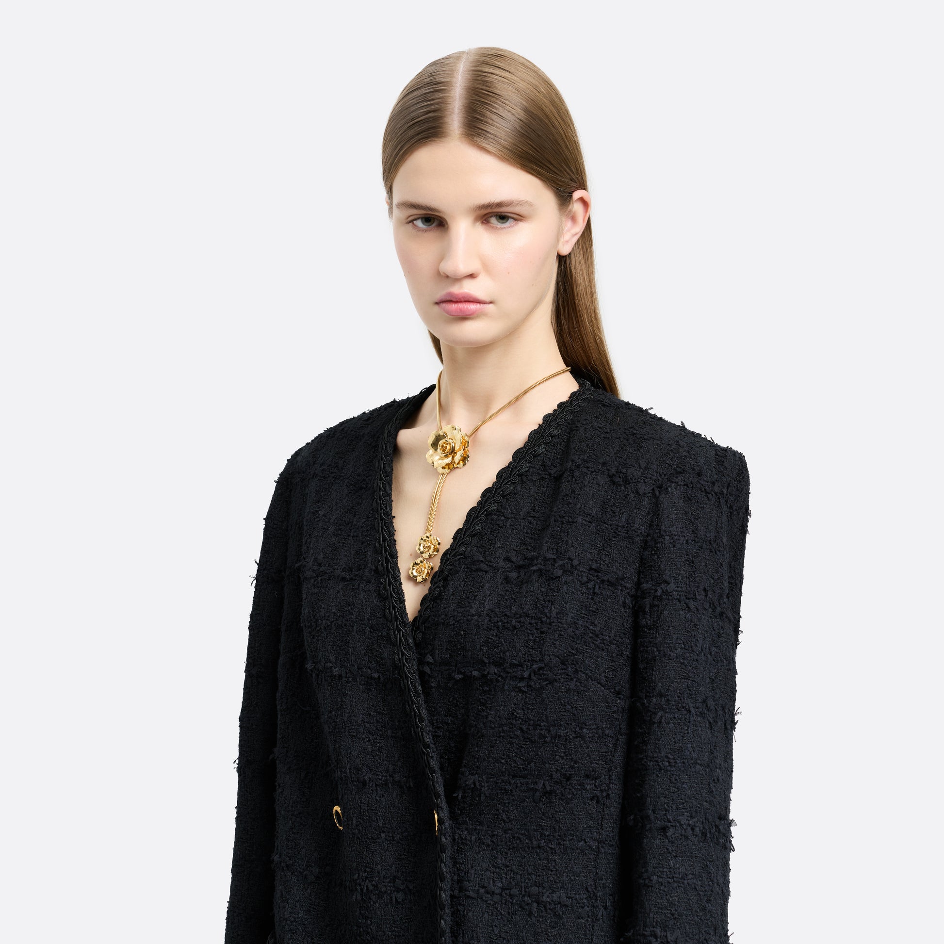 Gold-tone metal necklace centred by a floral motif. Finished with suspended flower charms and an adjustable chain fastening.

Featured in the Fall Winter 2026 Lookbook.