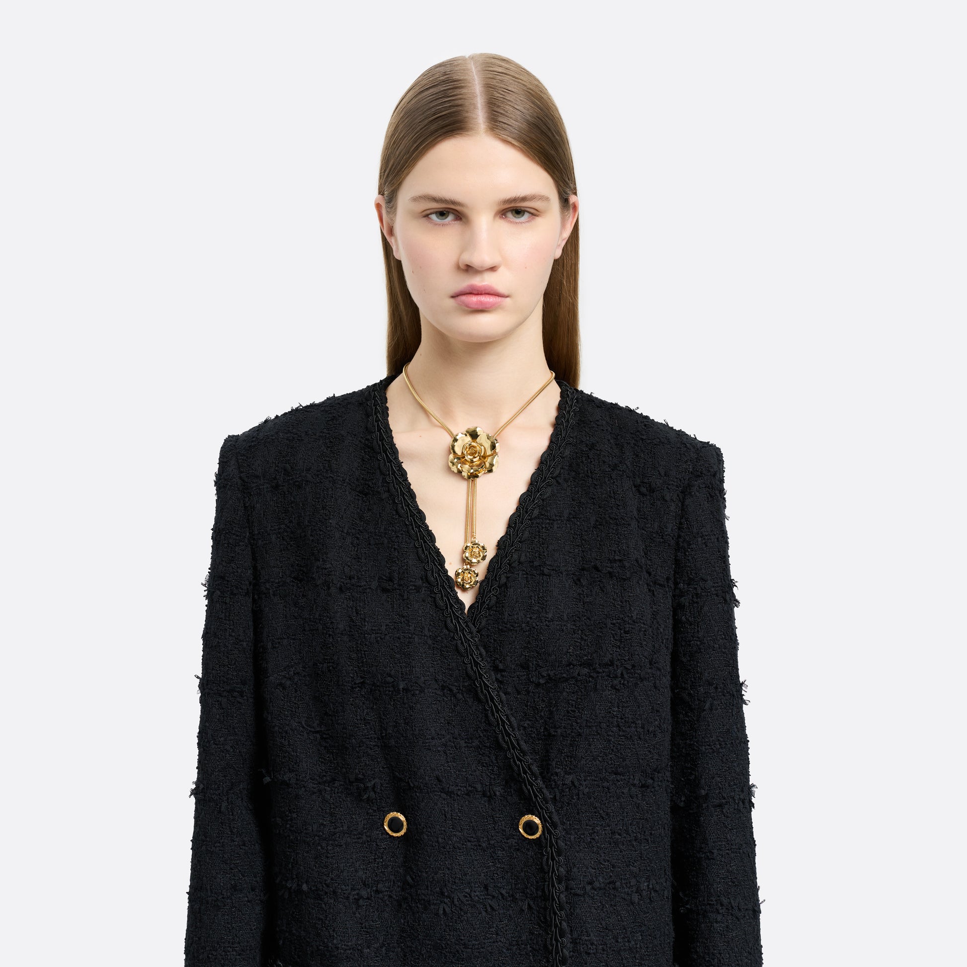 Gold-tone metal necklace centred by a floral motif. Finished with suspended flower charms and an adjustable chain fastening.

Featured in the Fall Winter 2026 Lookbook.