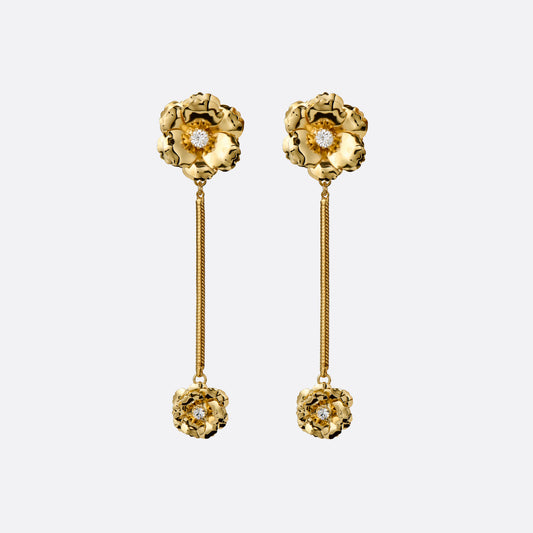 Gold-tone metal clip-on earrings with floral elements, crystal details and a chain drop.