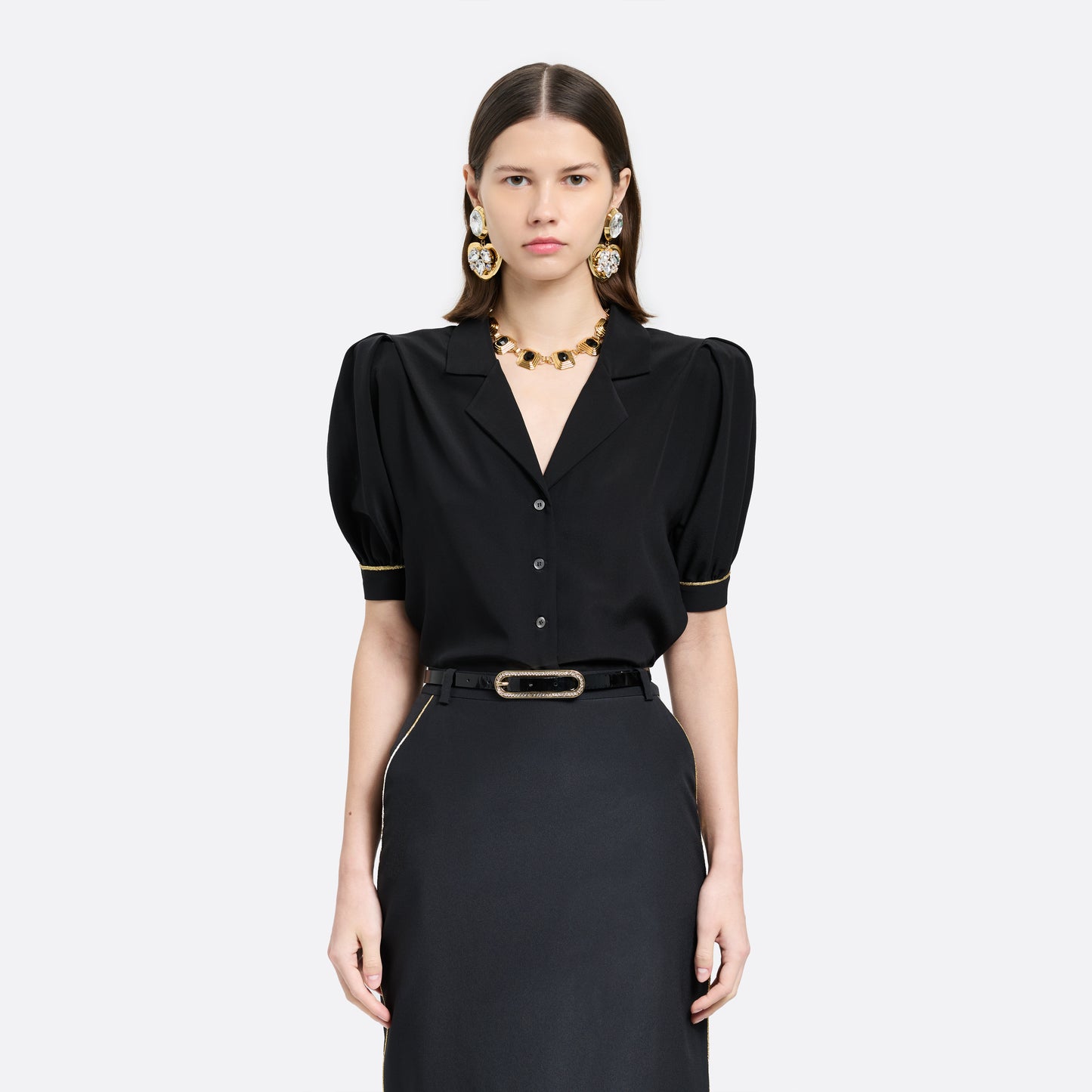 Black slim patent leather belt with oval crystal-embellished buckle.