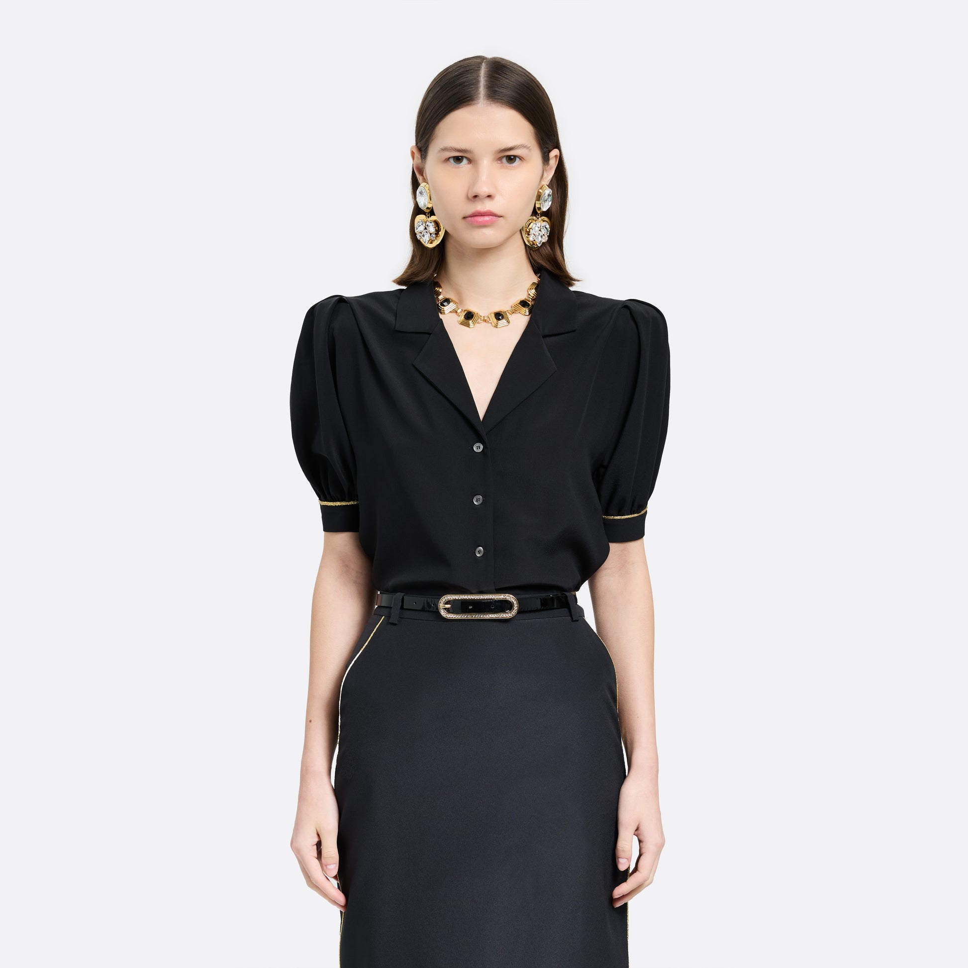 Black slim patent leather belt with oval crystal-embellished buckle.