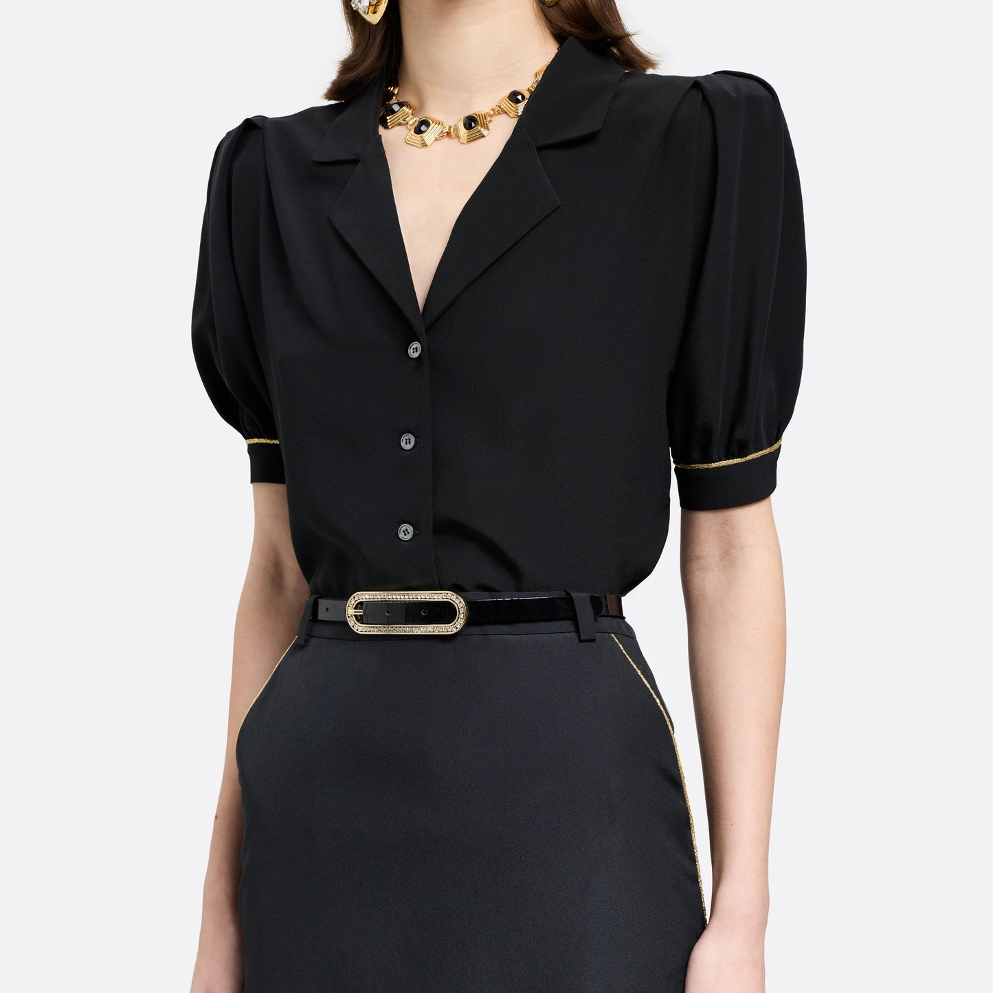 Black slim patent leather belt with oval crystal-embellished buckle.