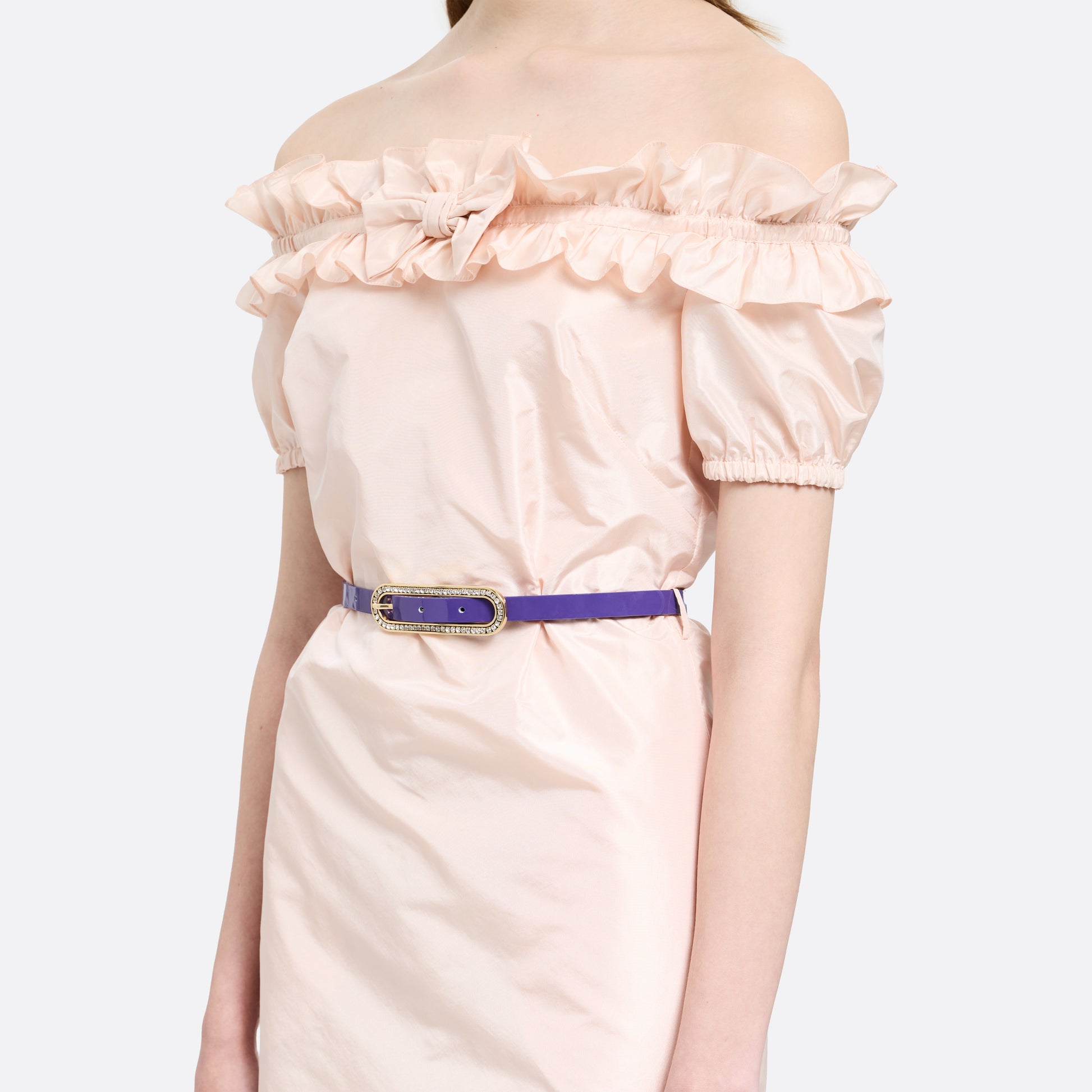 Purple slim patent leather belt with oval crystal-embellished buckle.