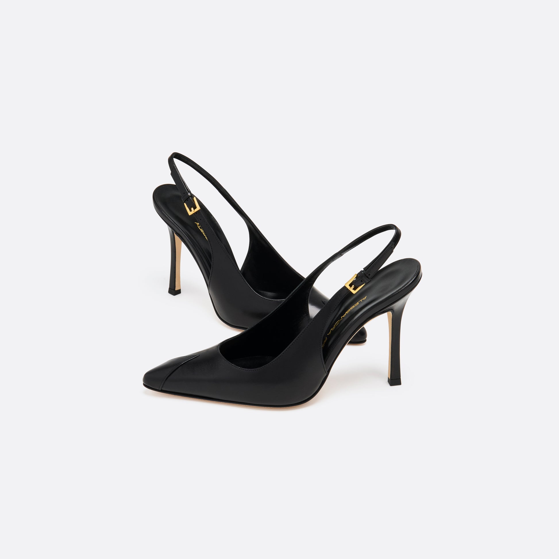 Black leather slingback pumps with a pointed toe detail and a 10.5 cm stiletto heel. Finished with an adjustable strap and a gold-tone buckle.
