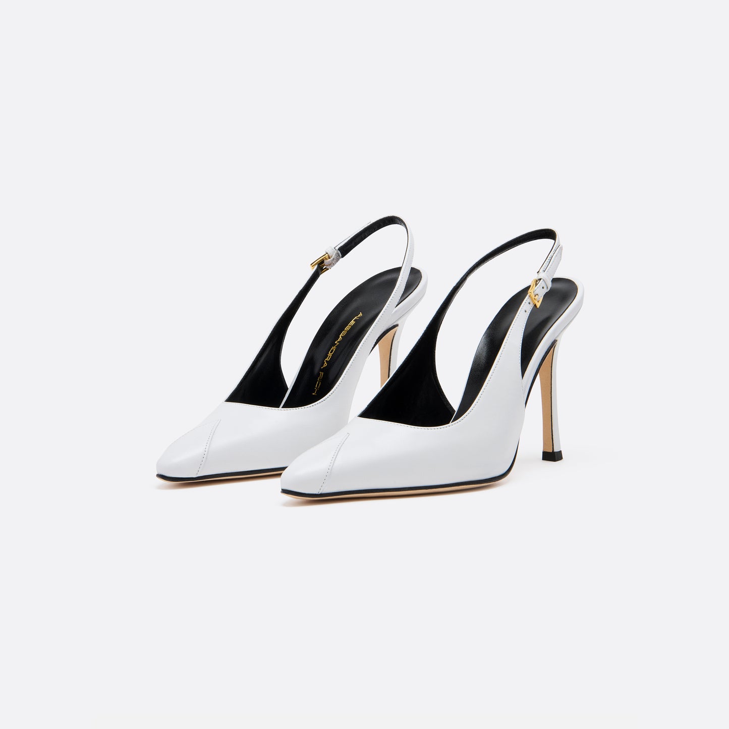 White leather slingback pumps with a pointed toe detail and a 10.5 cm stiletto heel. Finished with an adjustable strap and a gold-tone buckle.

Featured in the Fall Winter 2026 Lookbook.