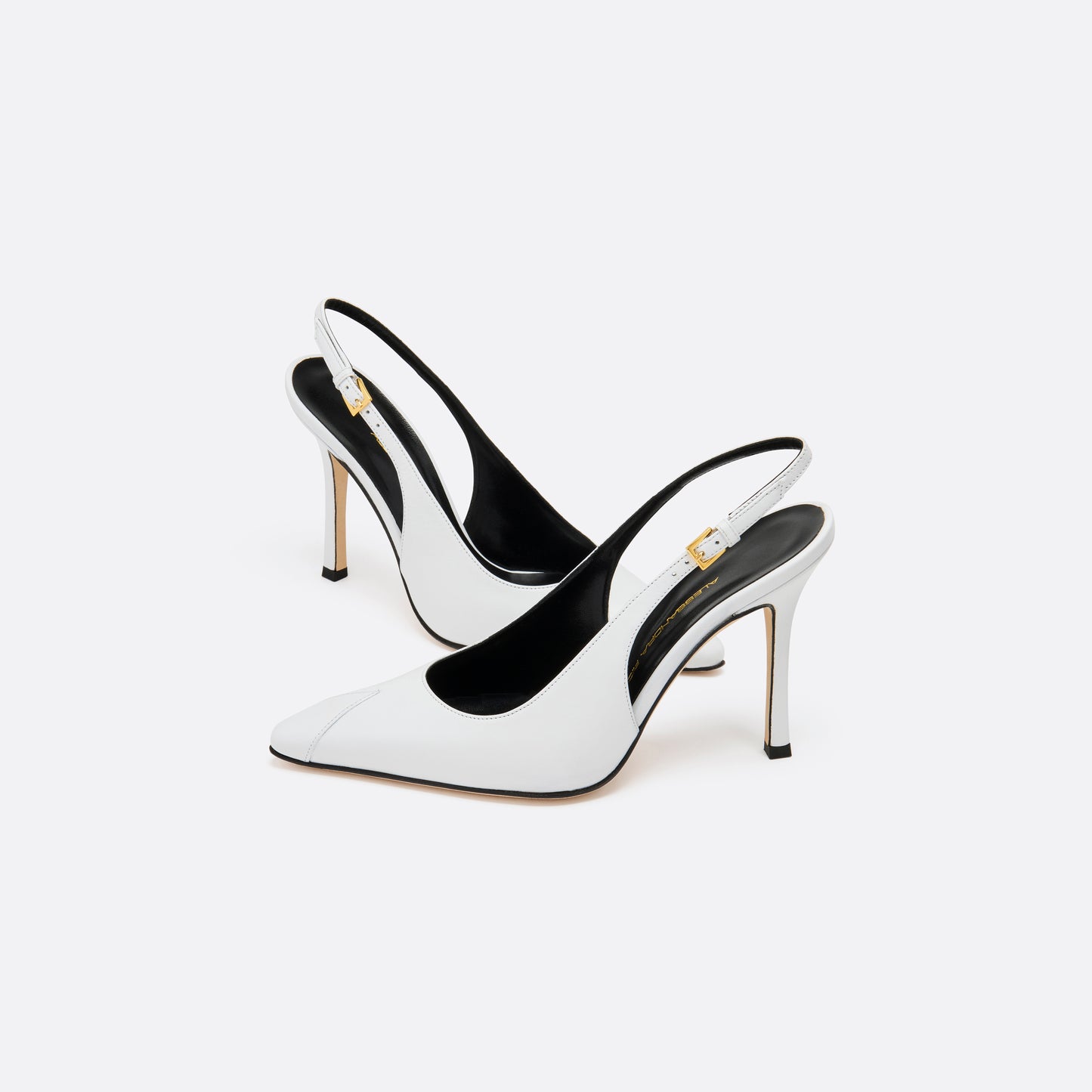White leather slingback pumps with a pointed toe detail and a 10.5 cm stiletto heel. Finished with an adjustable strap and a gold-tone buckle.