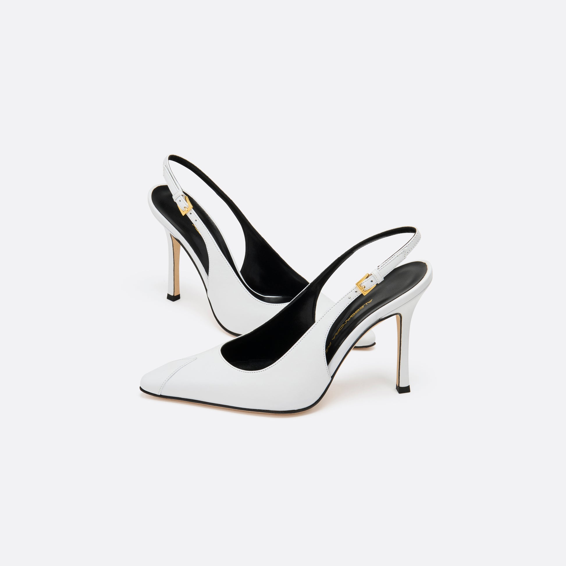 White leather slingback pumps with a pointed toe detail and a 10.5 cm stiletto heel. Finished with an adjustable strap and a gold-tone buckle.