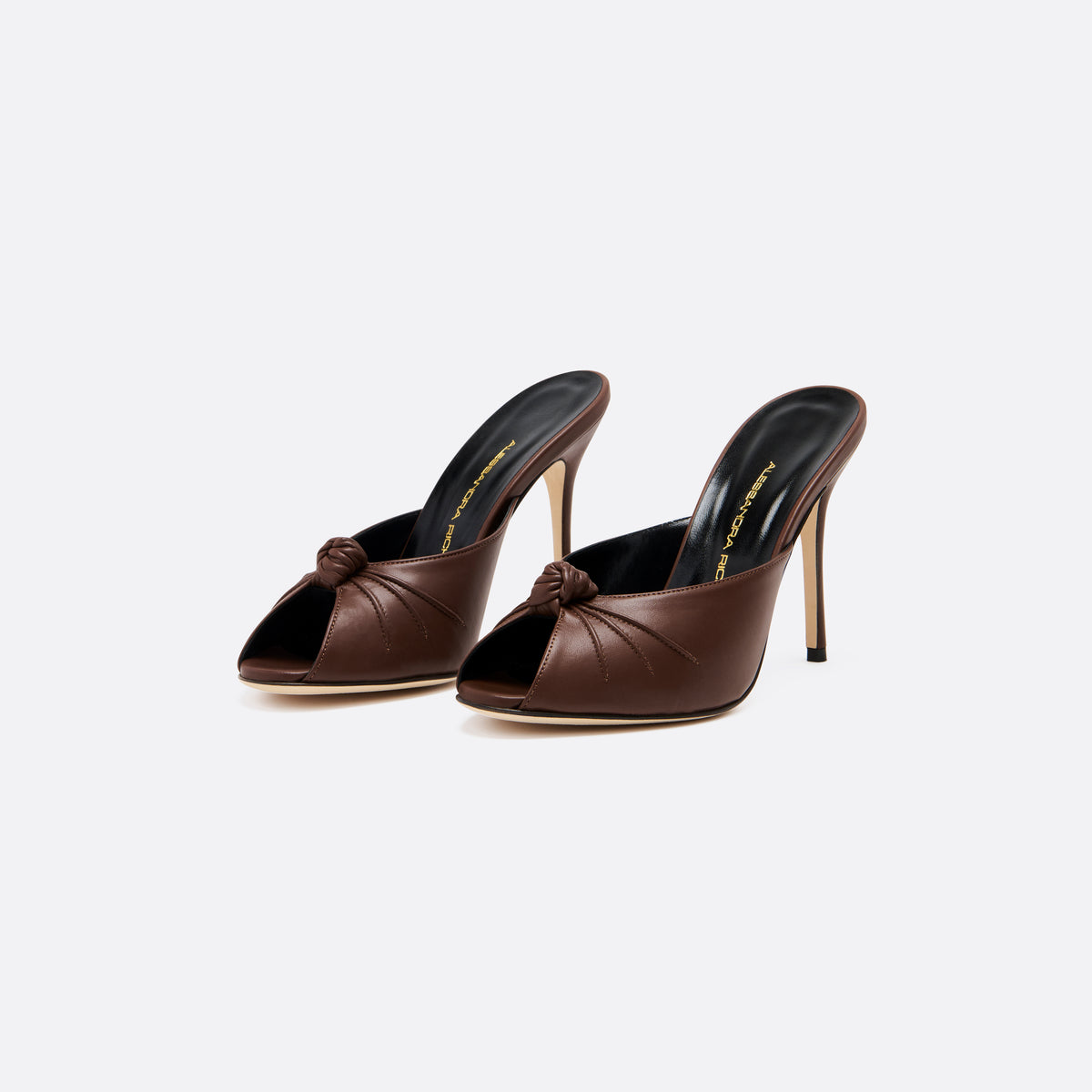 Brown leather mules with a peep toe and a 10.5 cm stiletto heel. Finished with a central knot detail.