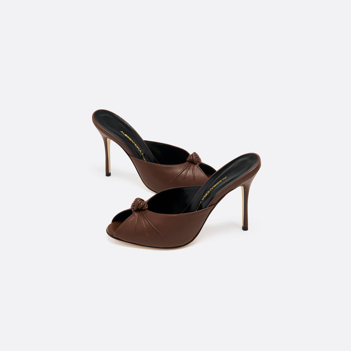Brown leather mules with a peep toe and a 10.5 cm stiletto heel. Finished with a central knot detail.
