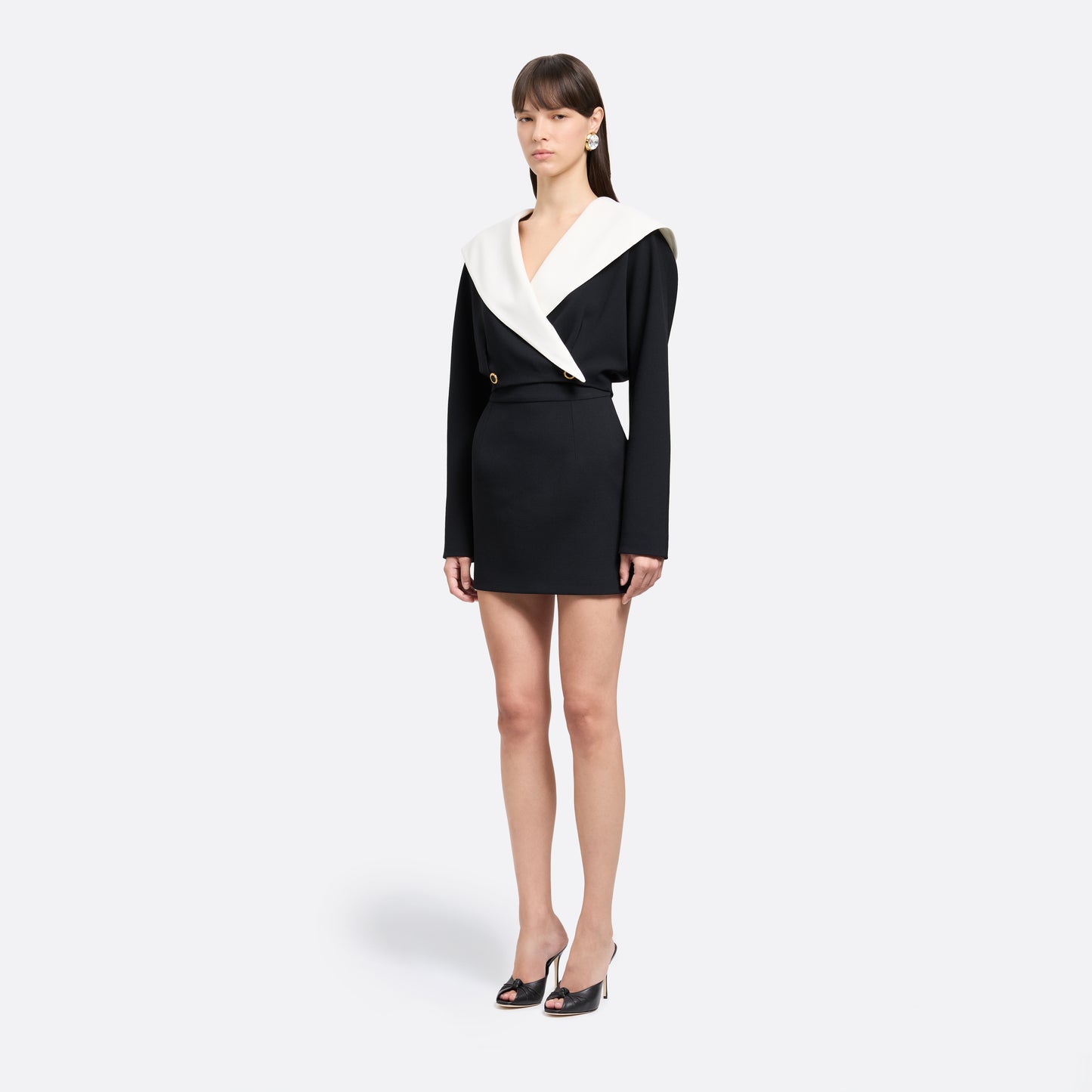 Black wool crêpe mini skirt with a high waist and a fitted silhouette.