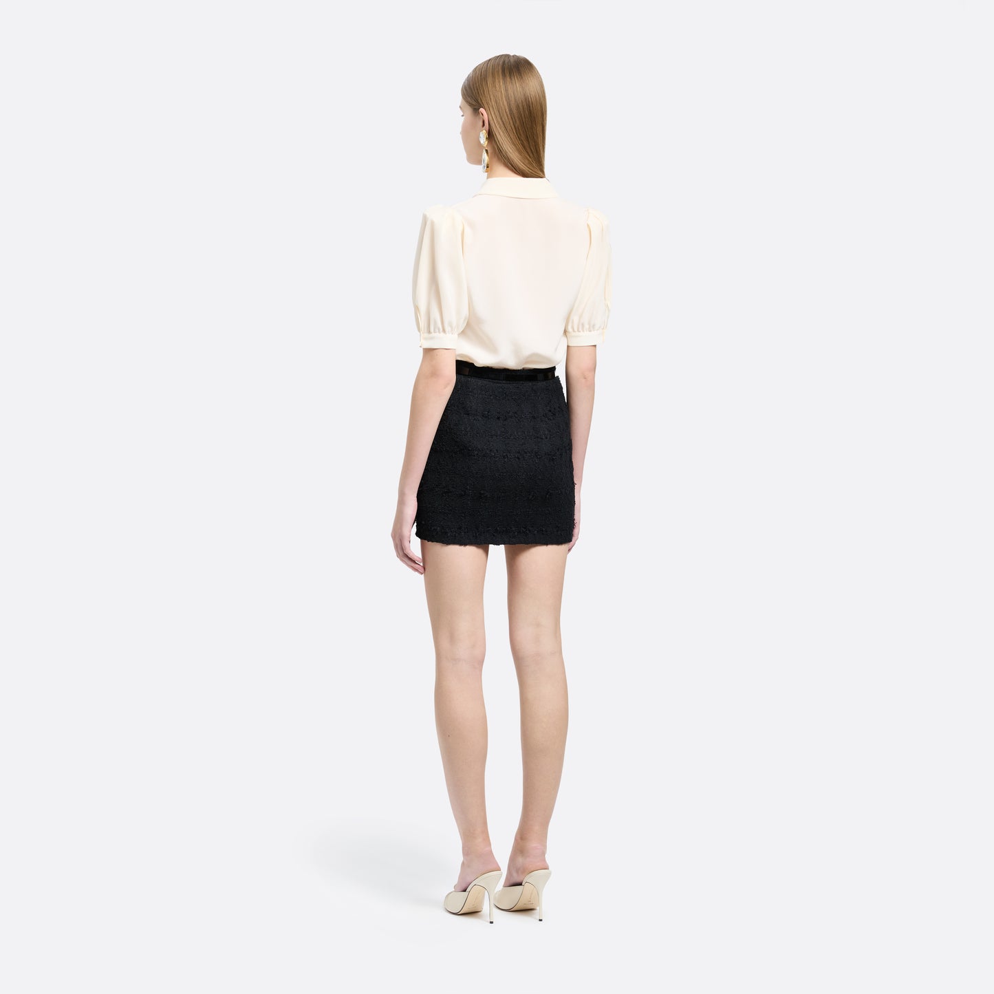 Black check tweed bouclé mini skirt with a high waist and a fitted silhouette.