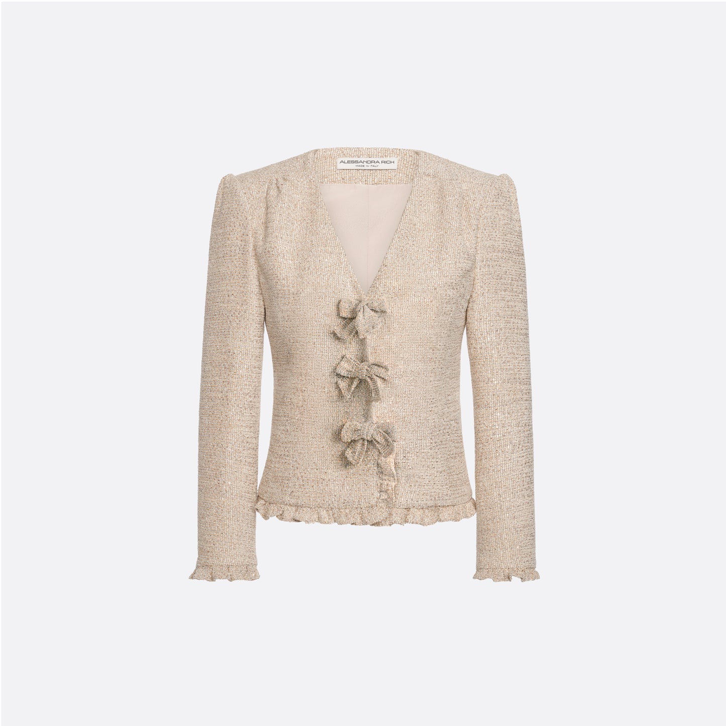 Beige sequin tweed jacket with V-neckline and long sleeves, featuring ruffle trims and bow.