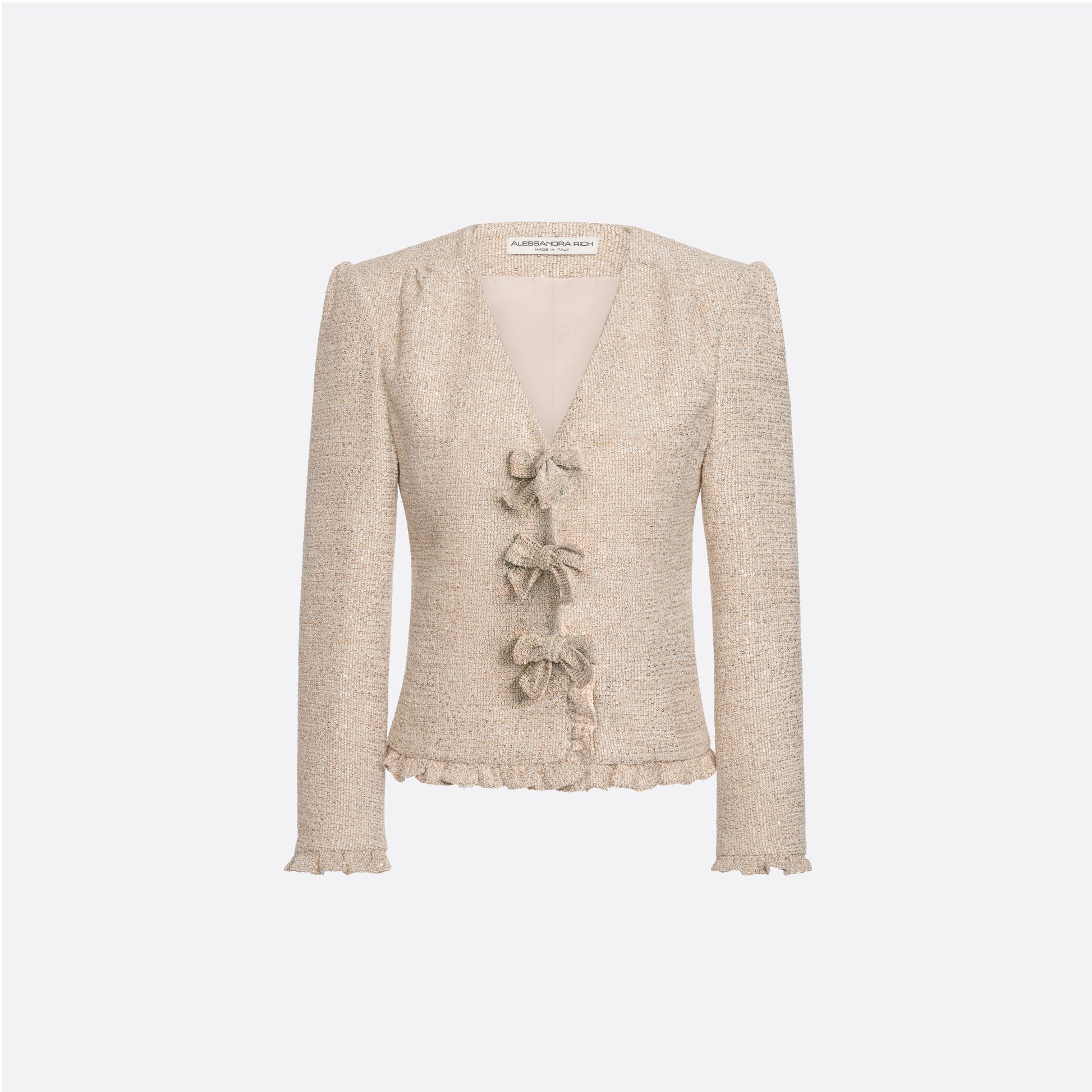 Beige sequin tweed jacket with V-neckline and long sleeves, featuring ruffle trims and bow.