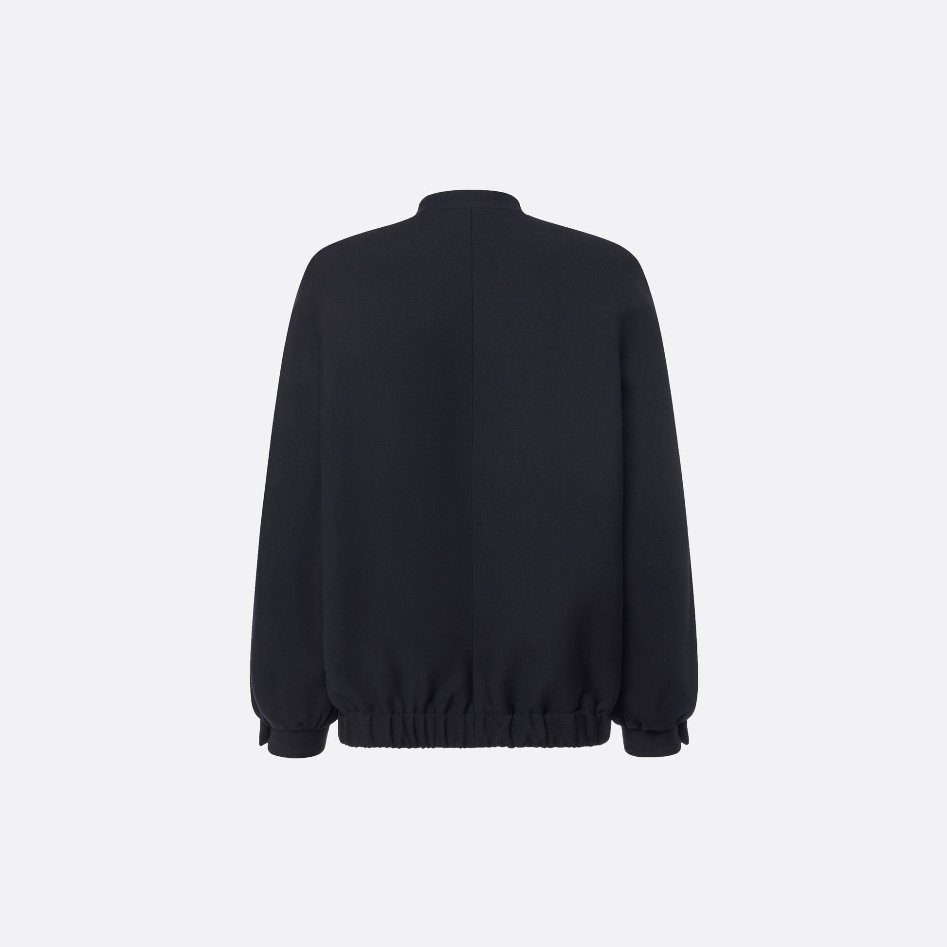 Oversized black wool blouson with a high neckline and long slevees, featuring jewel buttons.