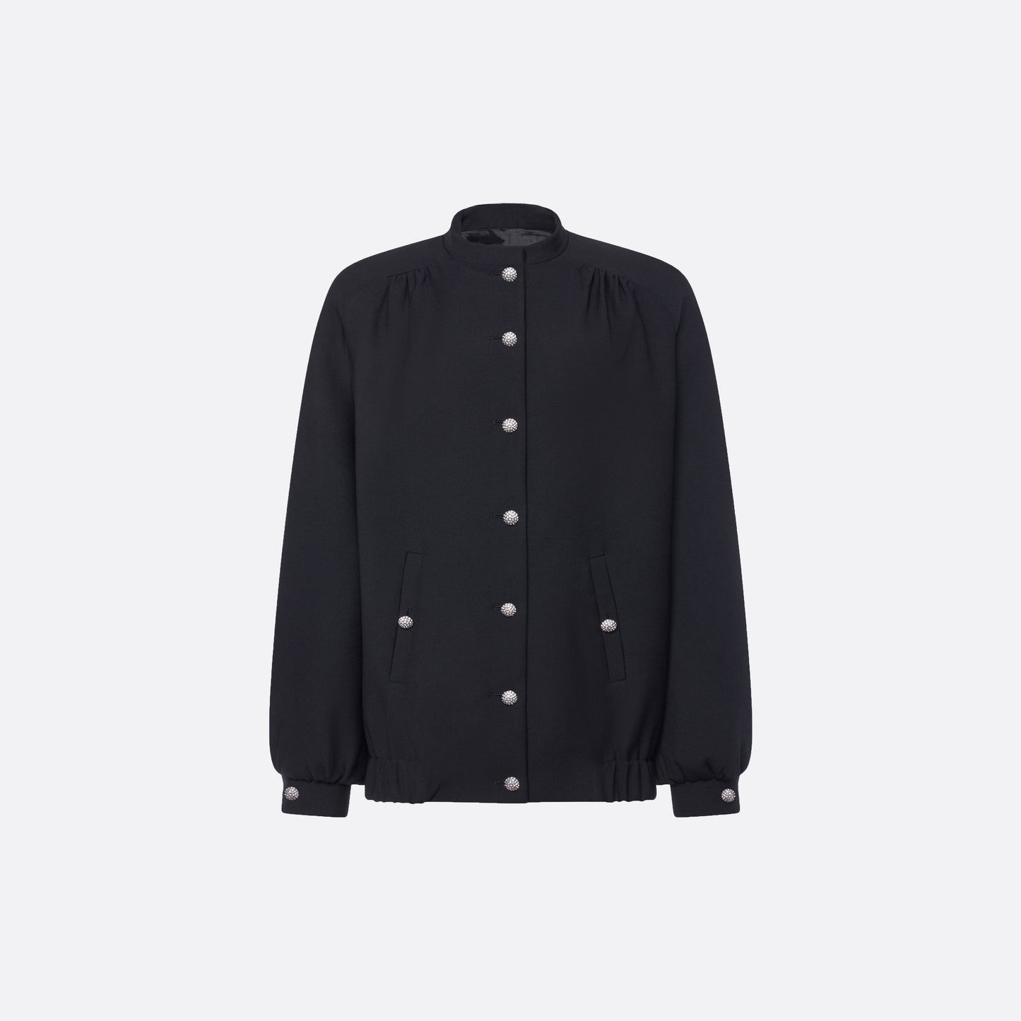 Oversized black wool blouson with a high neckline and long slevees, featuring jewel buttons.