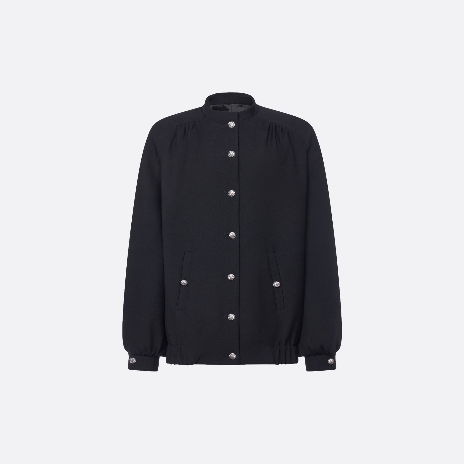 Oversized black wool blouson with a high neckline and long slevees, featuring jewel buttons.