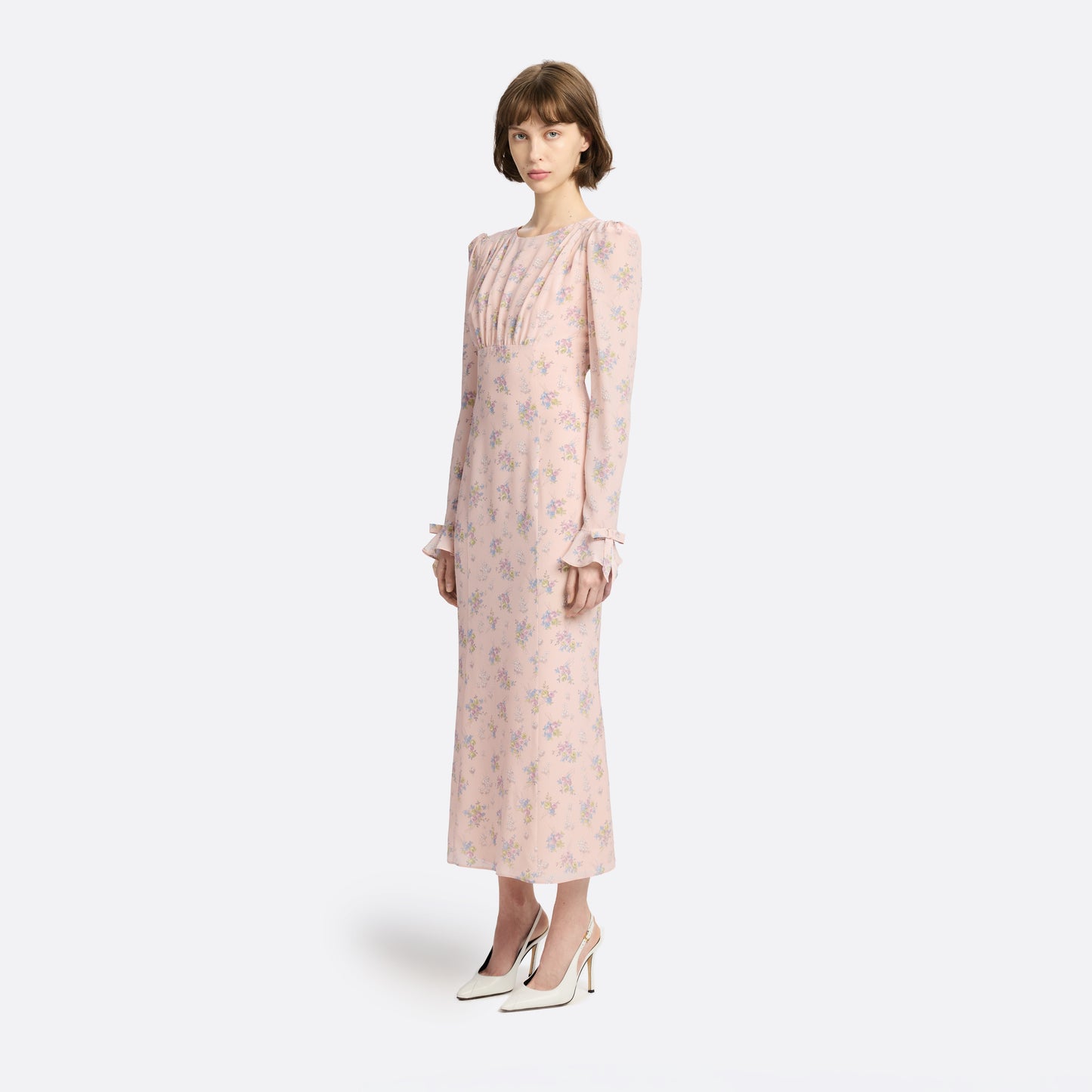 Light rose floral print silk crêpe de chine midi dress with long sleeves and open back, featuring ruffled cuffs and bows.