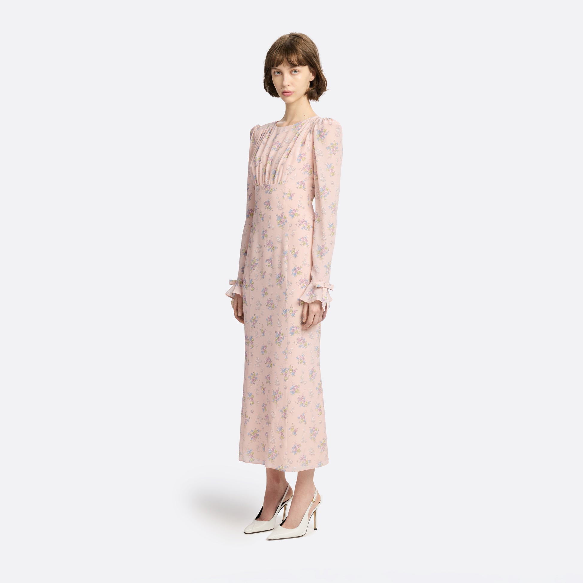 Light rose floral print silk crêpe de chine midi dress with long sleeves and open back, featuring ruffled cuffs and bows.