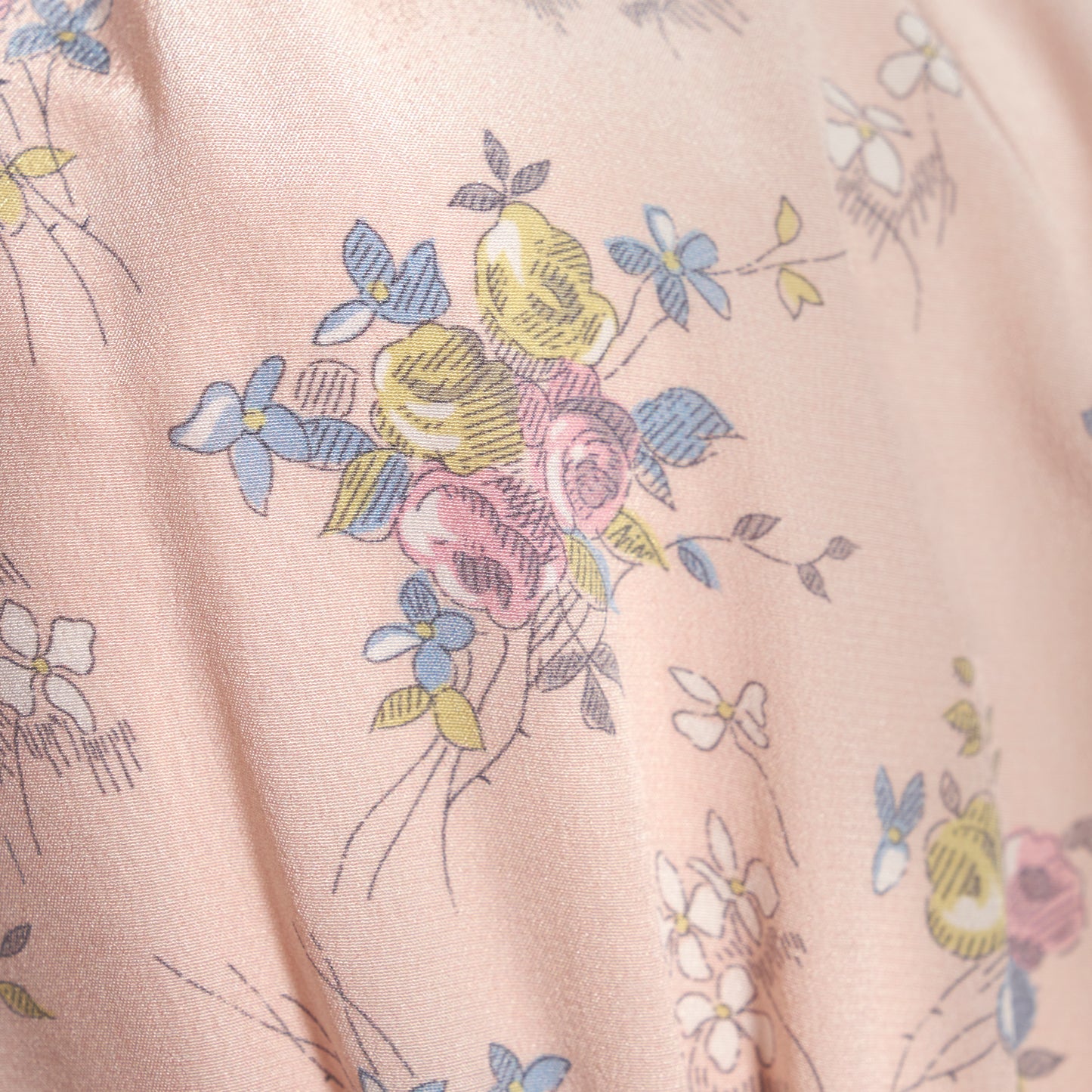 Light rose floral print silk crêpe de chine midi dress with long sleeves and open back, featuring ruffled cuffs and bows.